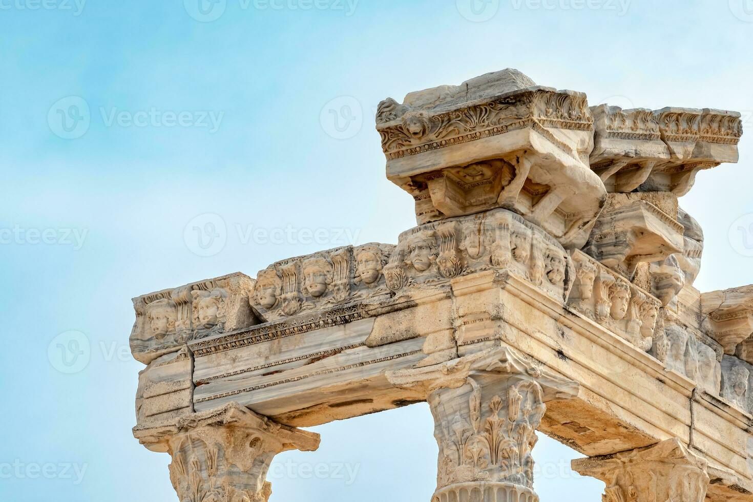 fragment of the colonnade of the destroyed temple of Apollo in Side with a stone-cut relief on the frieze photo