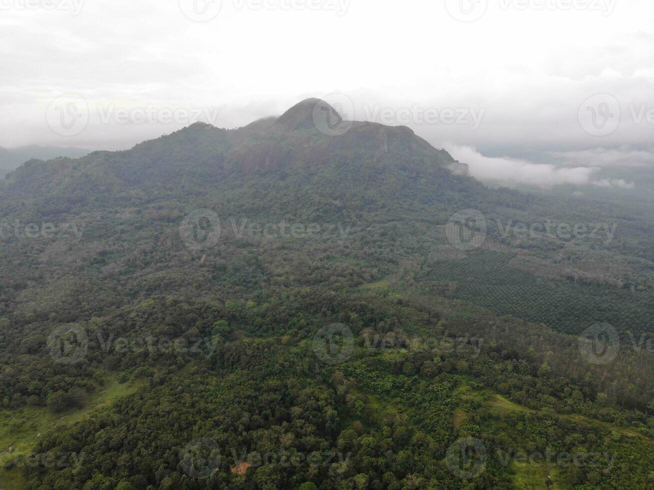 a view of the mountains from a hillside. Serelo Hill is located in Perangai Village, Lahat regency, and it becomes one of popular landmark in Lahat regency. photo