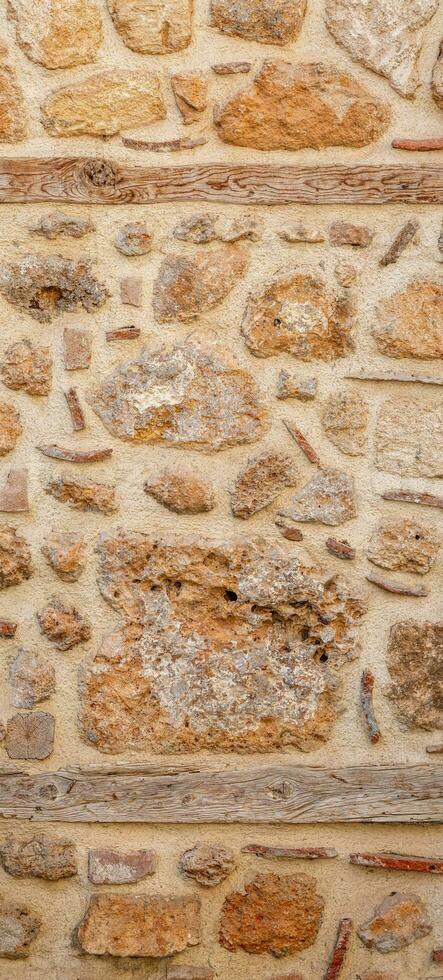 background, texture - rough masonry from wild stone and cement on a wooden frame photo