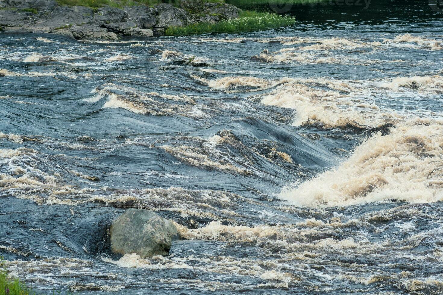 turbulent stream in the river rapids photo