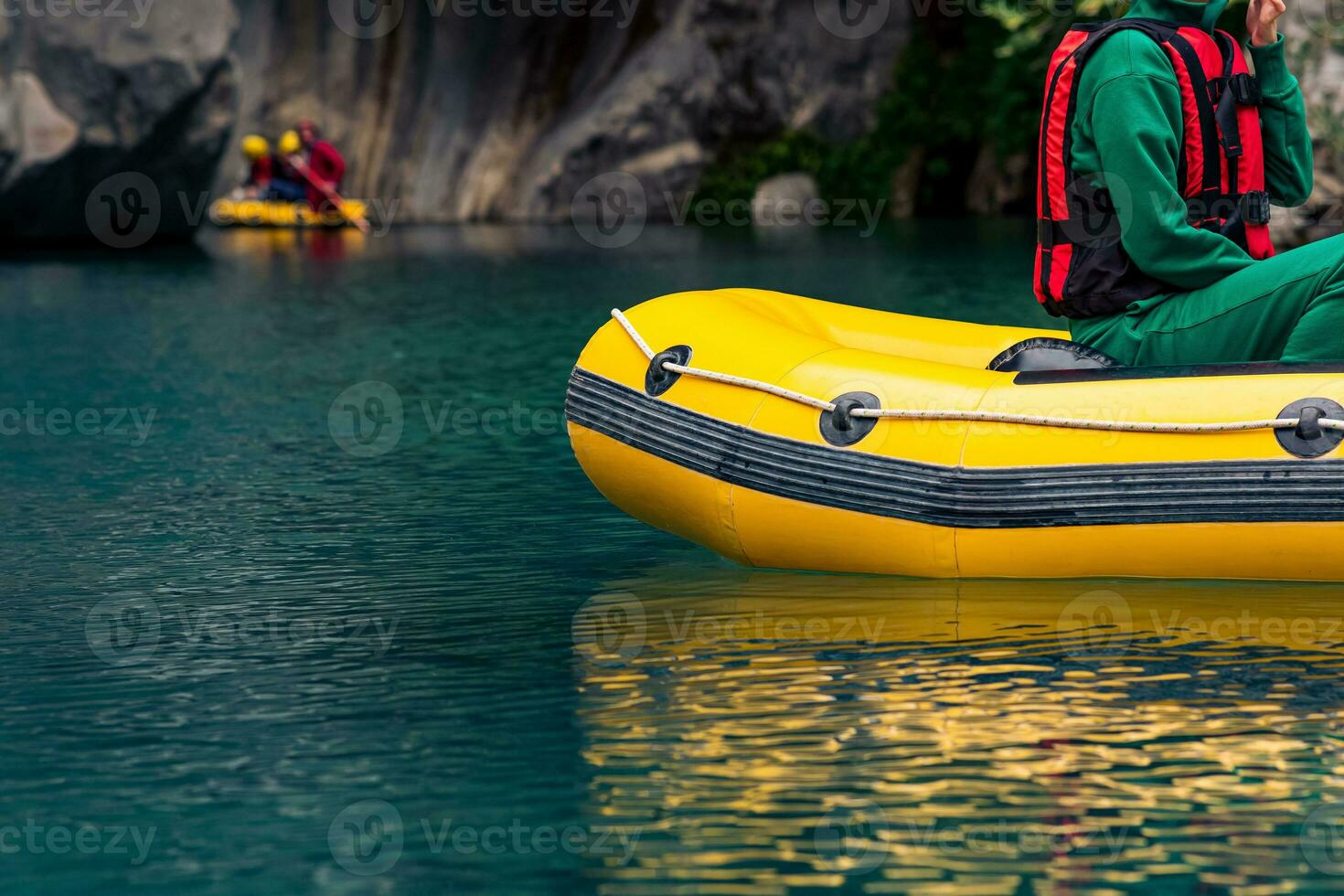 tourists on an inflatable boat rafting down the blue water canyon in Goynuk, Turkey photo