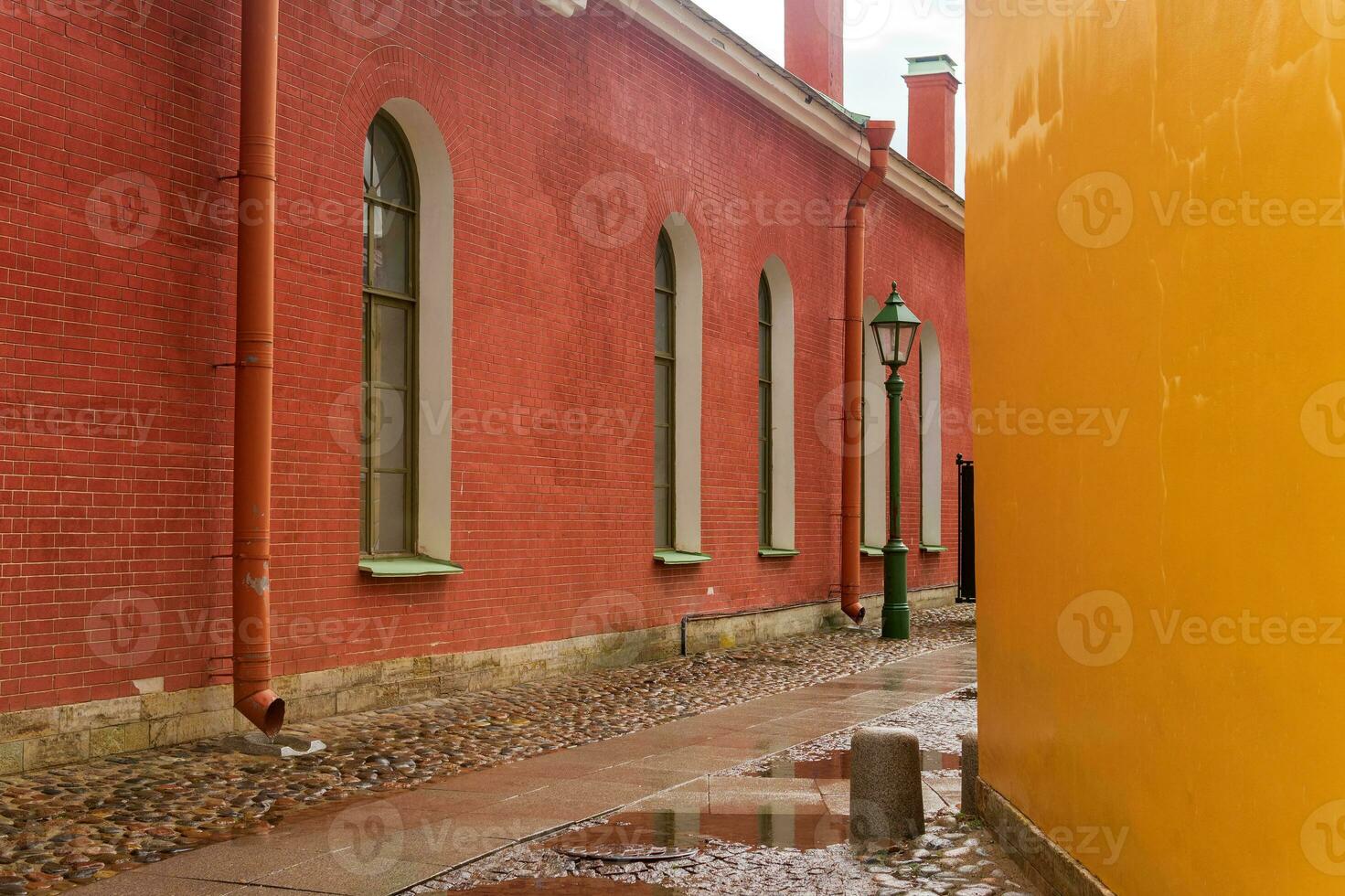 alley between ancient buildings with colored walls in a historical city photo