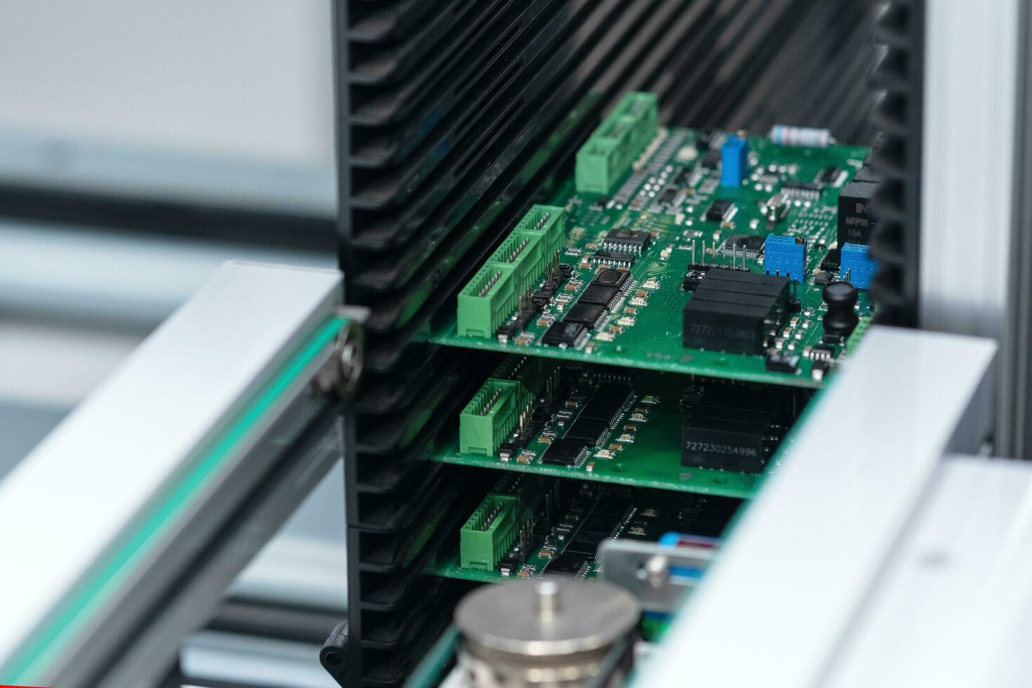 stage of printed circuit board production on the conveyor of automatic production line photo