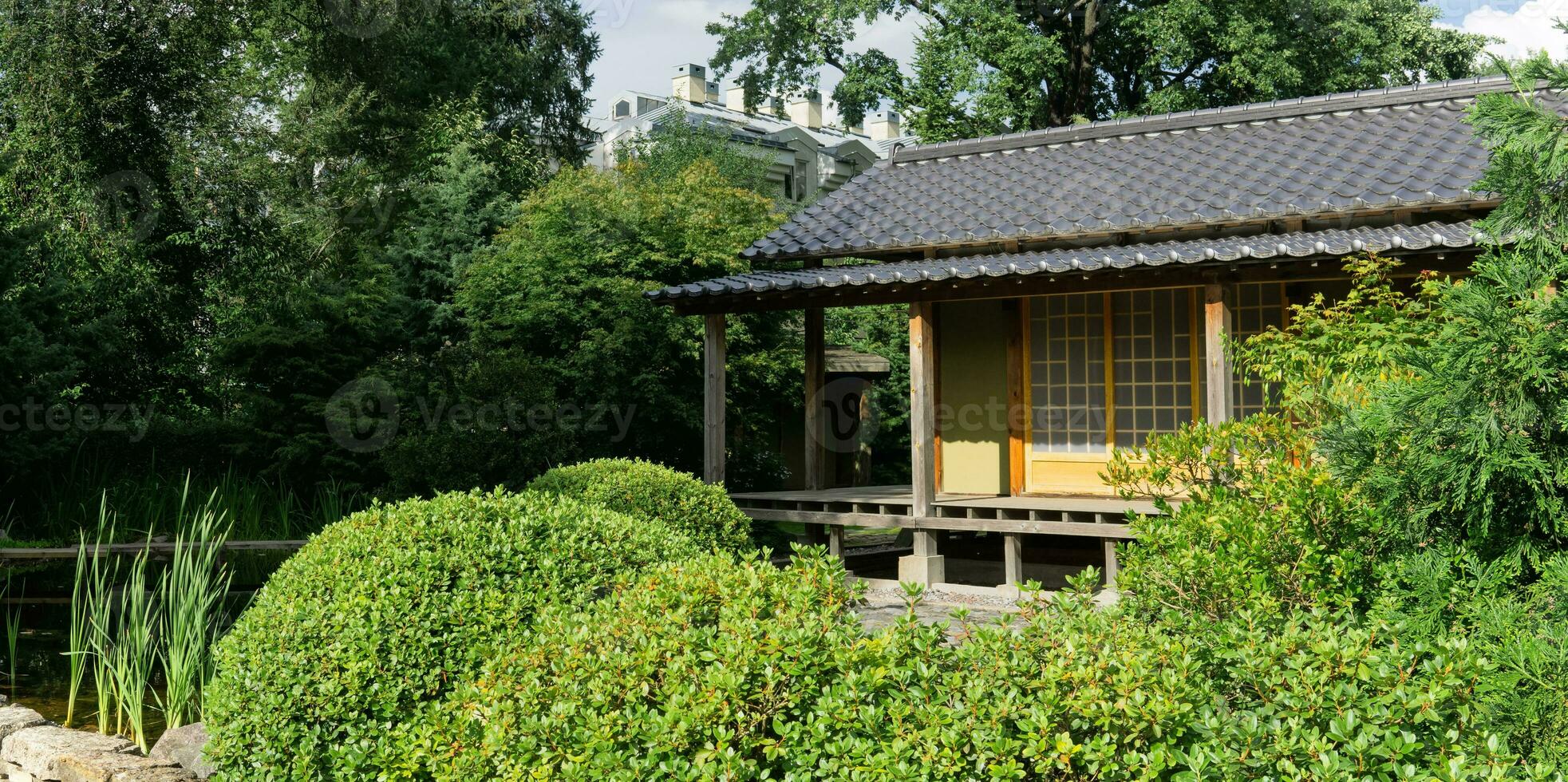 tea house behind pond in japanese garden photo