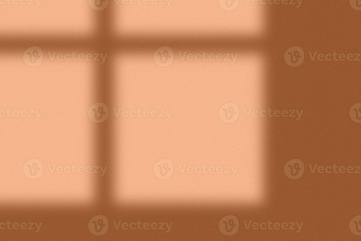 Black shadows on concrete wall in Peach Fuzz color of the year. Shadow overlay effect. Scene of natural lighting. Blank space background for design and text. Background for ideas. photo