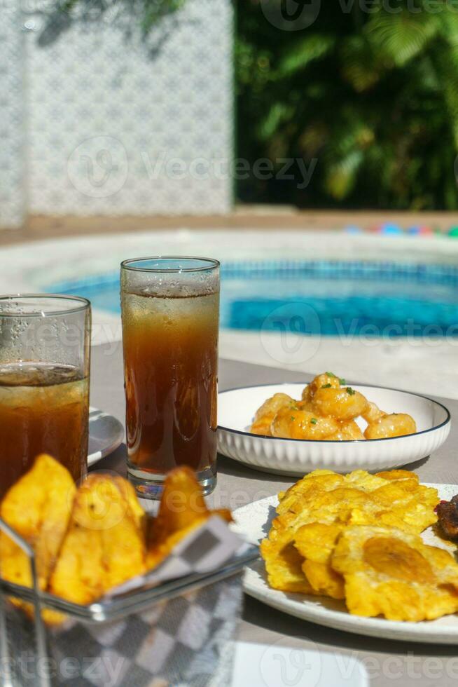 Food and glasses of ice tea on the table photo