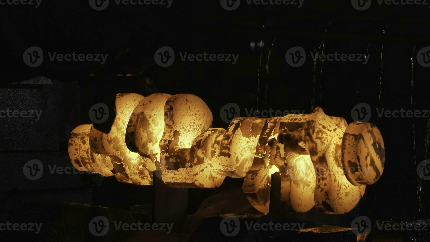 Close up view of hot steel forging process with big mechanical hammer machine and red hot billet. Scene. Industrial details of metallurgic factory or plant. photo