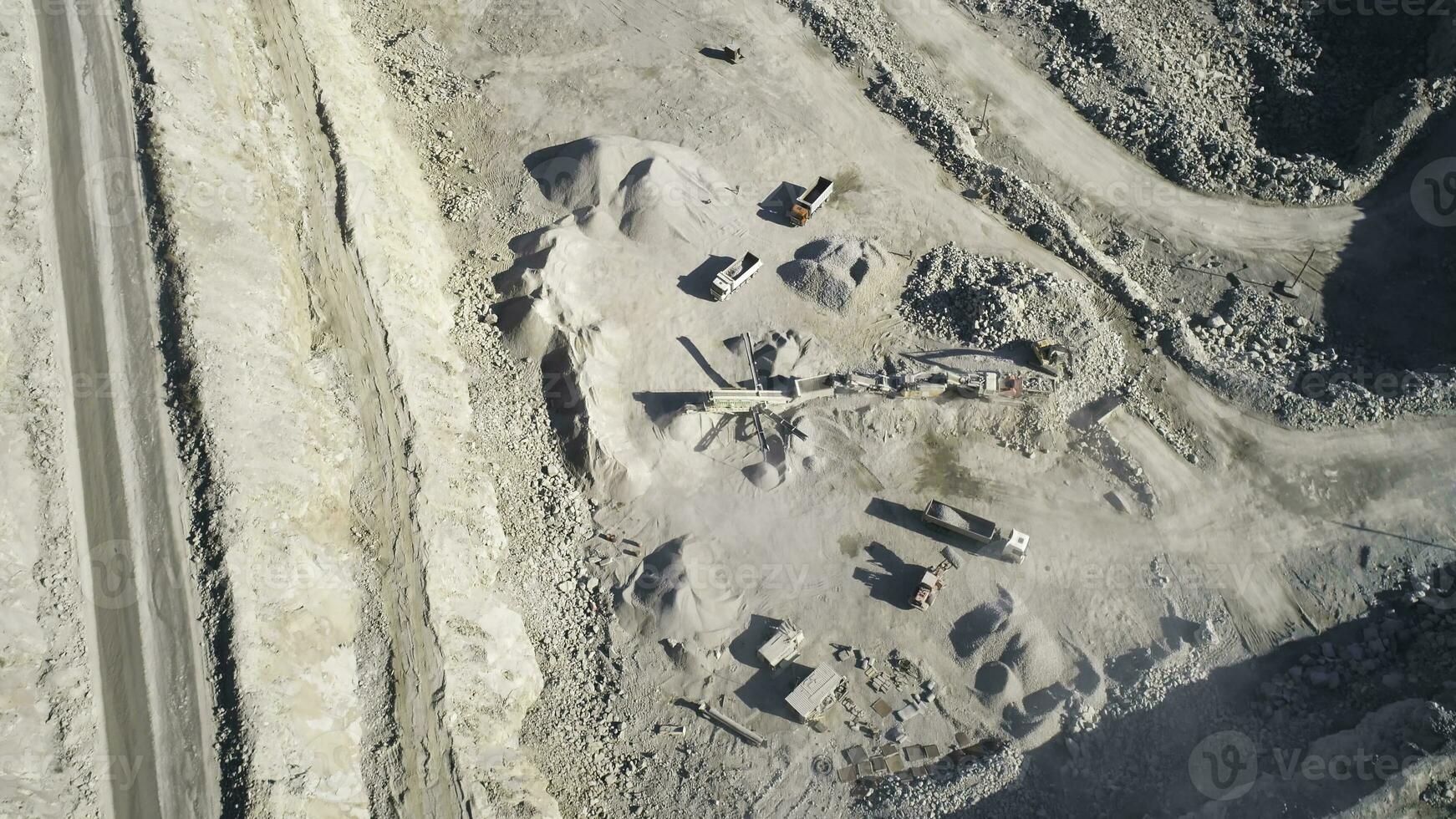 Top view of sand quarry with excavators. Shot. Open pit mining operations with operating excavators. Mining industry concept photo