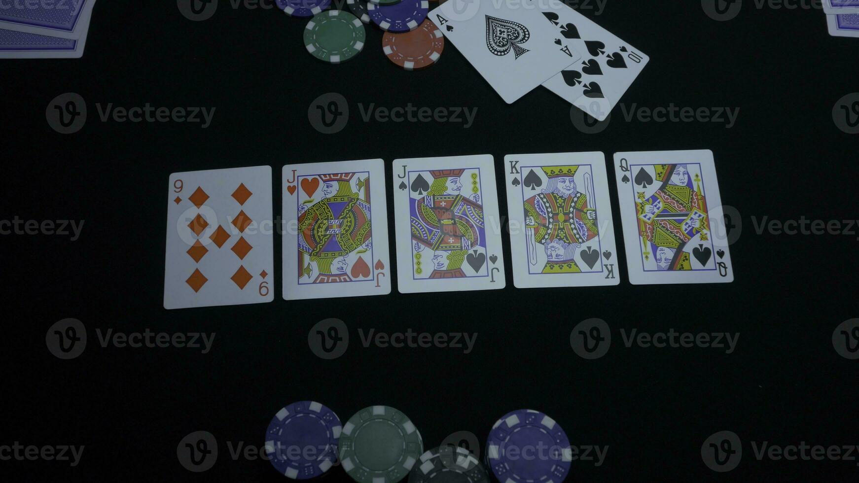 Detail of a royal flush on black background. Royal Flush of spade in poker game on a black background. Player collected The Royal Flush on a green poker table against black. photo