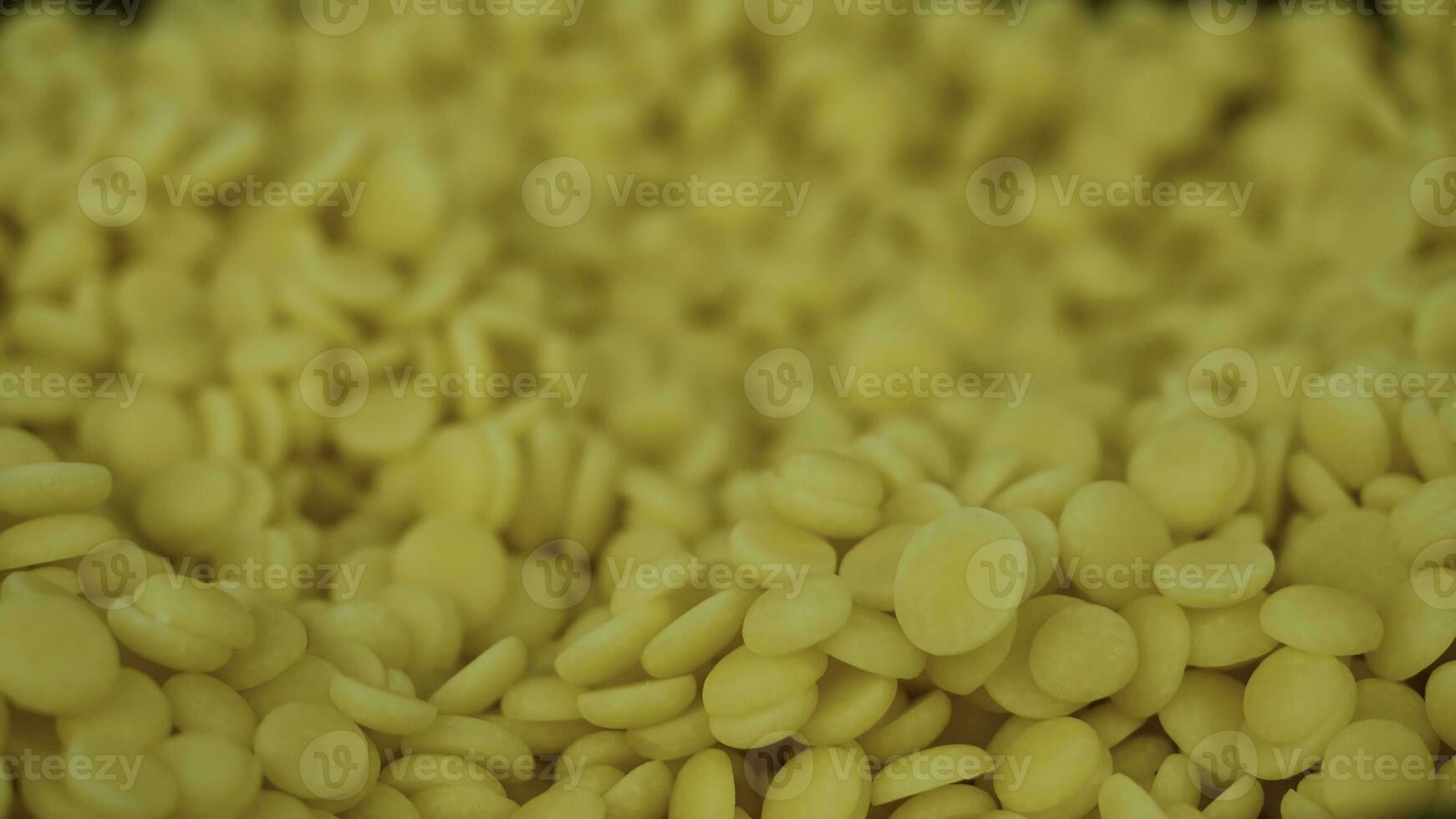 Yellow pills for dessert. Yellow dragees for cake, closeup photo