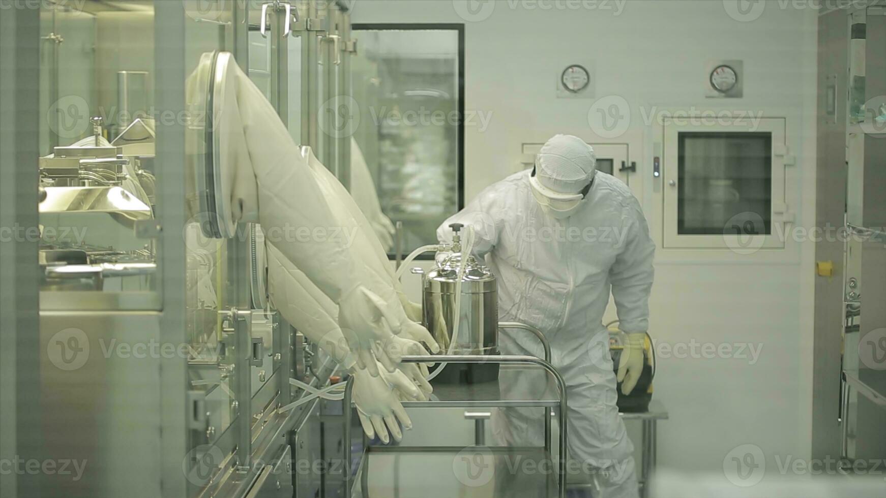 Pharmaceutical industry. Male factory worker inspecting quality of pills packaging in pharmaceutical factory. Automatic tape to create packaging and filling of medicines. control in the factory of photo