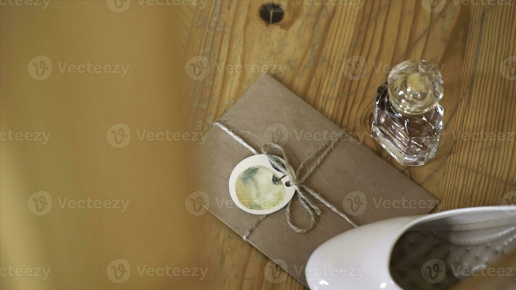 Women's white shoes on paper envelope and paper perfume. Envelop and perfume. Pair of beige women's high-heeled shoes. Pair of white women's high-heeled shoes photo