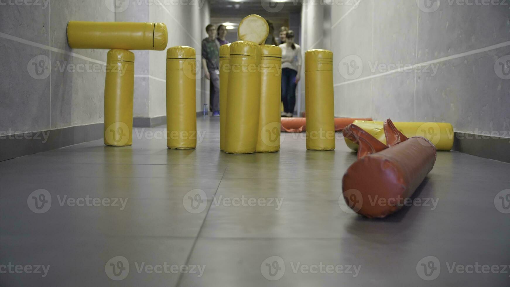 Hit of skittles game in the hall. Both casts into figure of artillery are success in streets of gorodki game photo