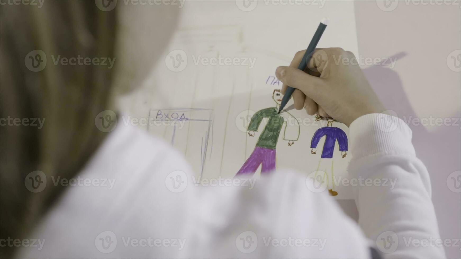 Little child draws a pencil on a sheet of paper. Action. A young girl draws on a sheet of paper. A gift for mom photo