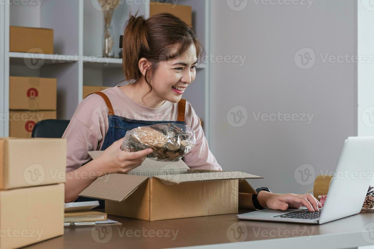 Portrait of Starting small businesses SME owners female entrepreneur working on receipt box and check online orders to prepare to pack the boxes, sell to customers, SME business ideas online. photo
