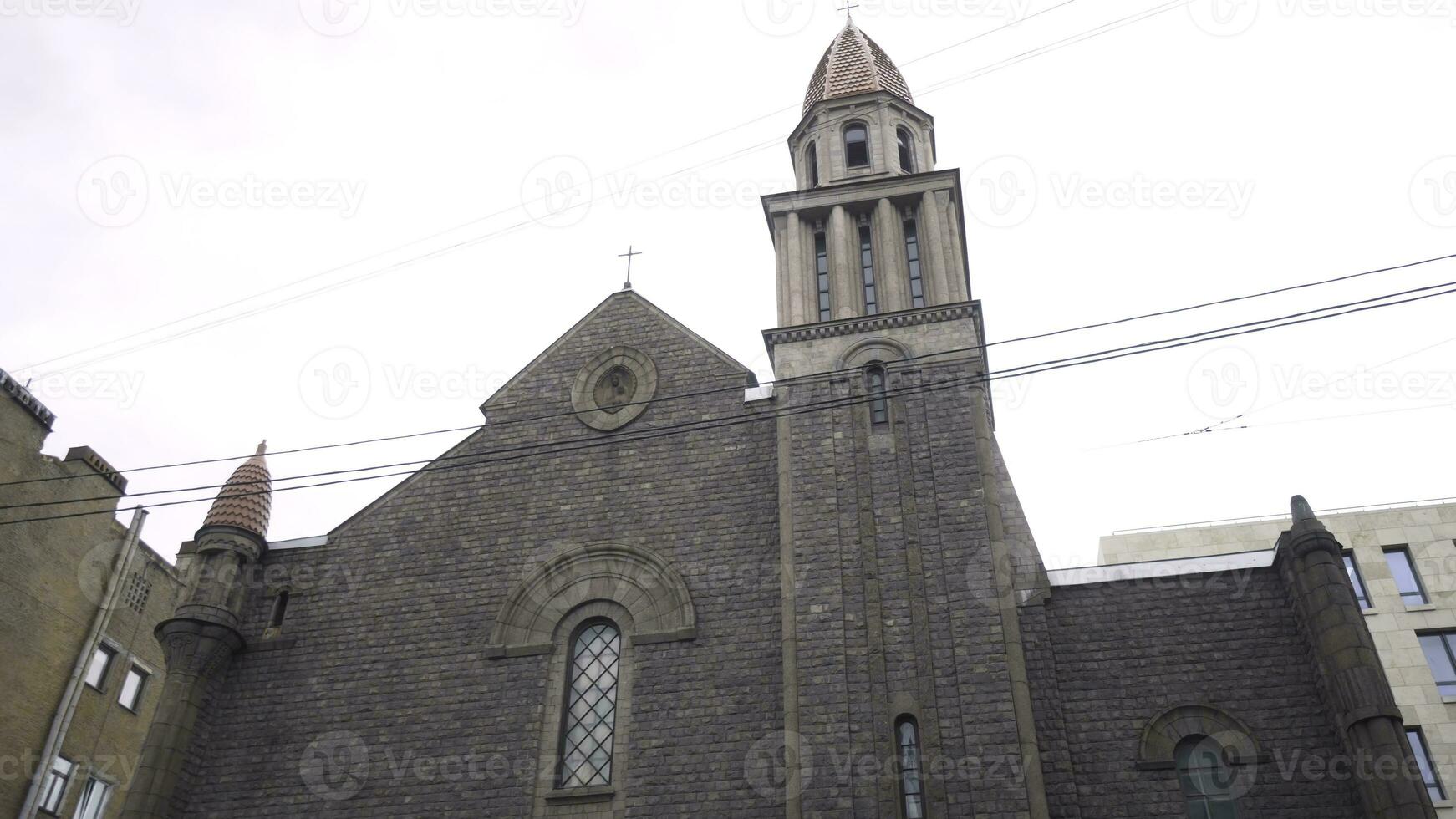 Dark brick architecture of Catholic Church in city. Action. Catholic old Church with dark appearance. Religious attraction and architecture. Our lady of Lourdes Roman Catholic Church photo