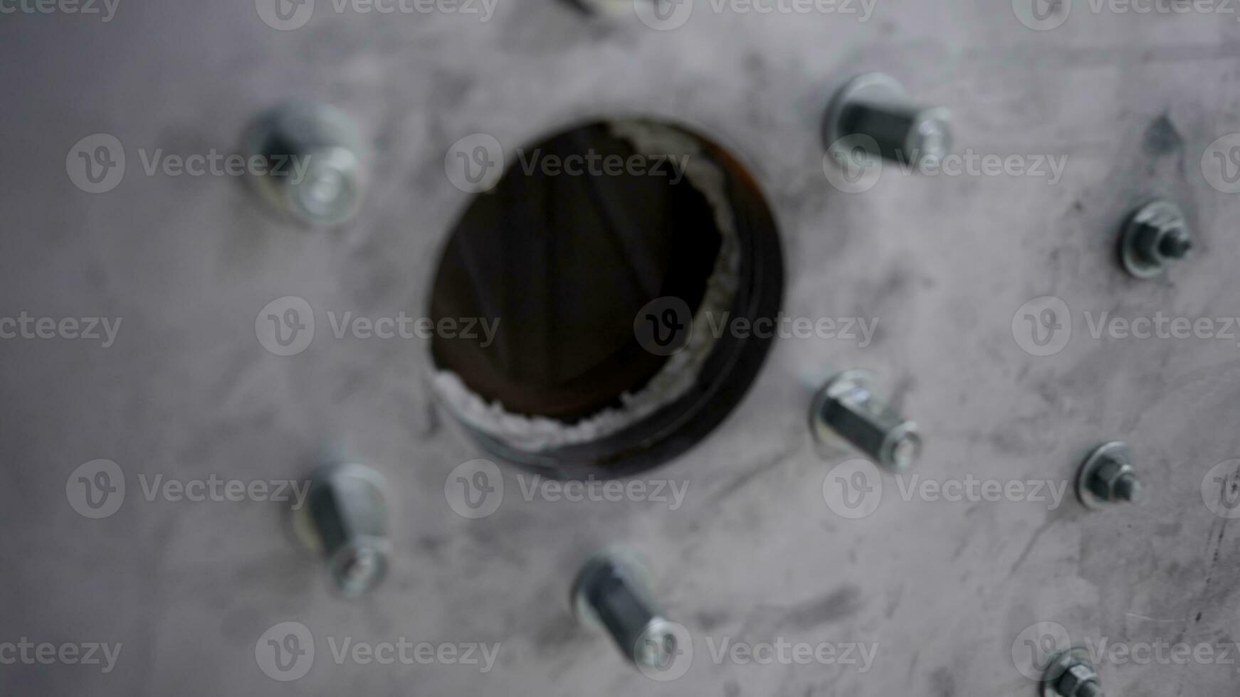 Close-up of melting furnace. Steel closed chamber metal melting furnace with glass round window to observe melting process photo
