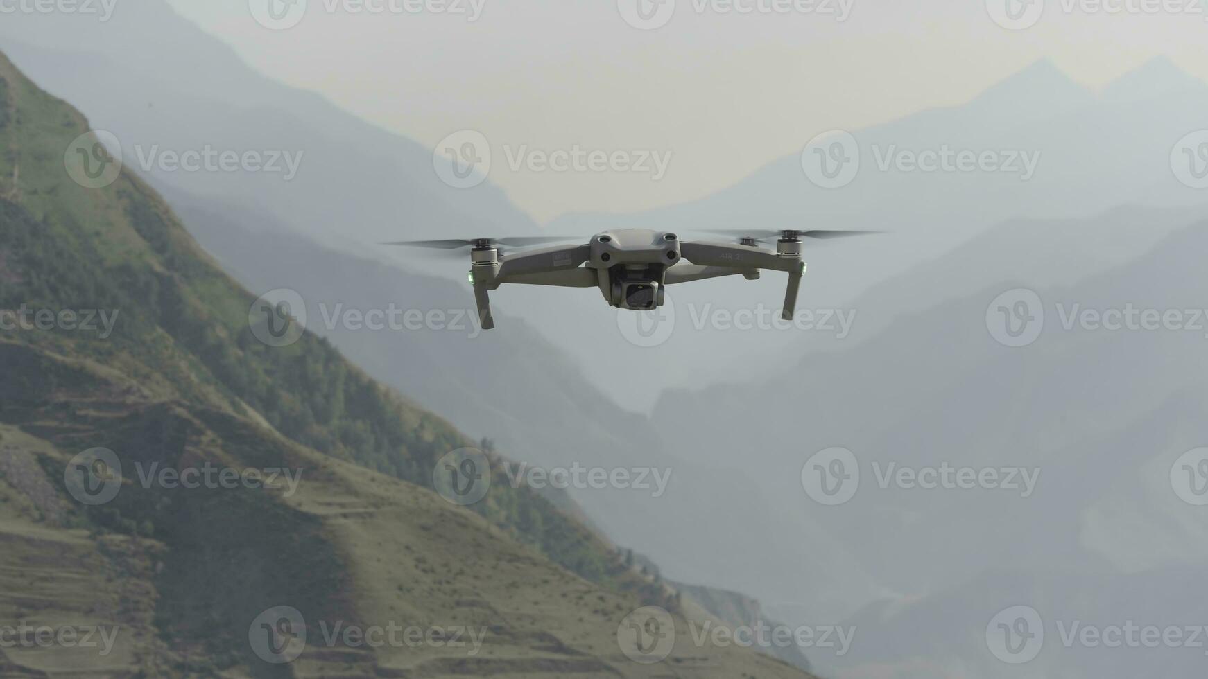 Flying drone in air. Action. Drone flies over beautiful mountain landscape on sunny day. Drone in air shoots mountain landscape photo
