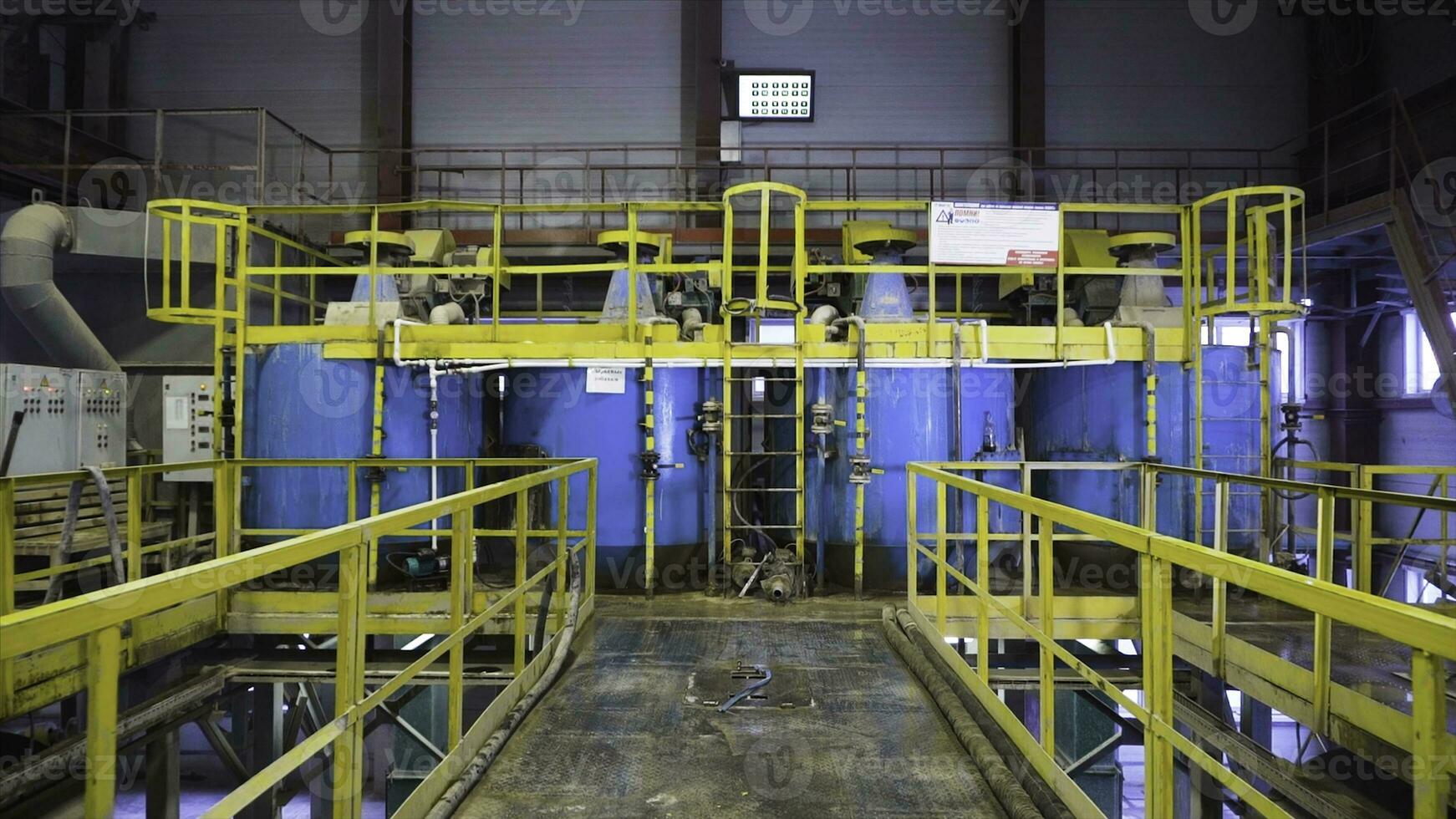 Boilers for raw materials in factory. Stock footage. Huge boilers for storing or mixing raw materials in factory. Inside modern raw material plant photo