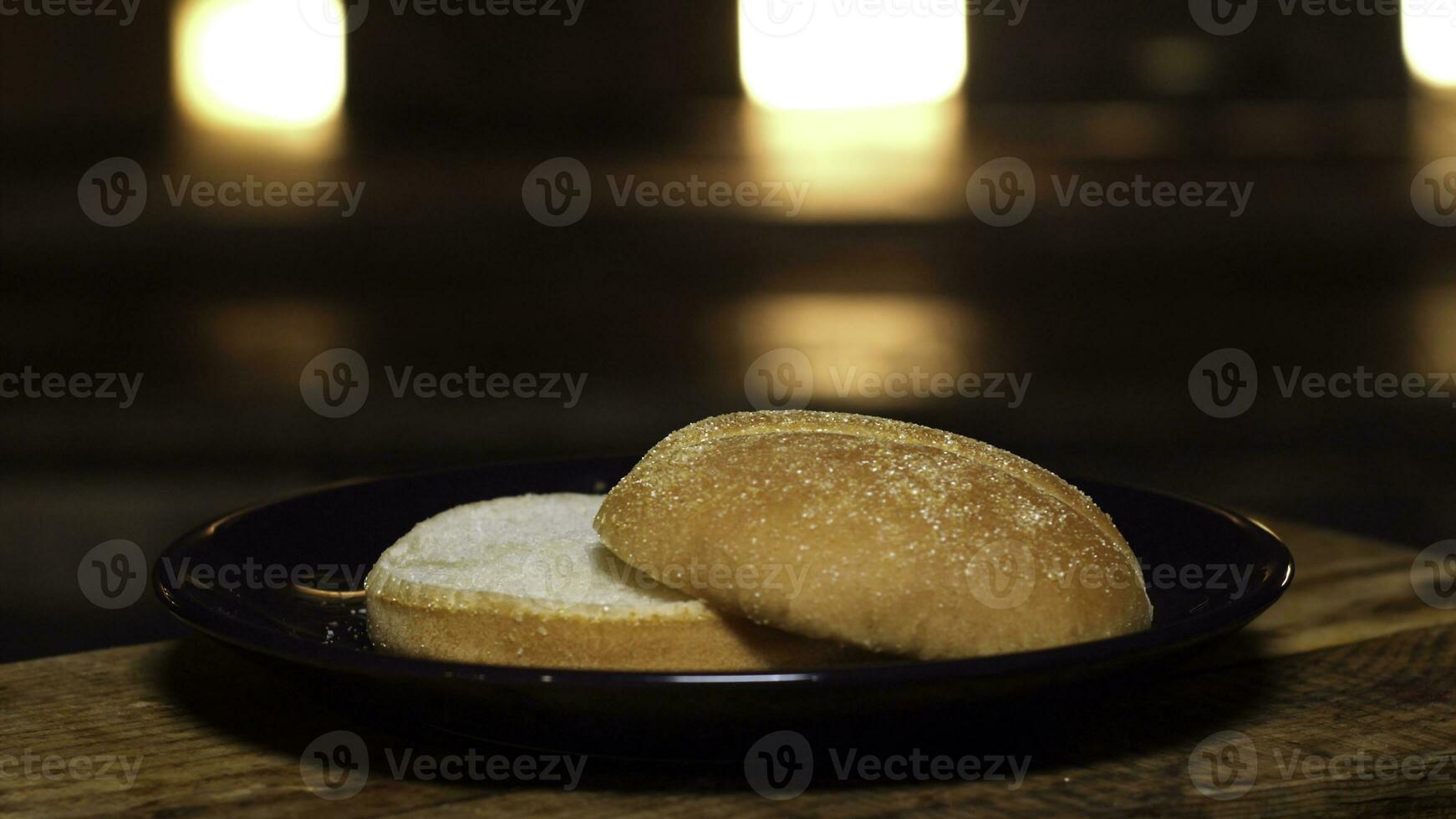 Burger bun on a plate. Stock footage. Appetizing bun for cooking a Burger. Delicious food photo