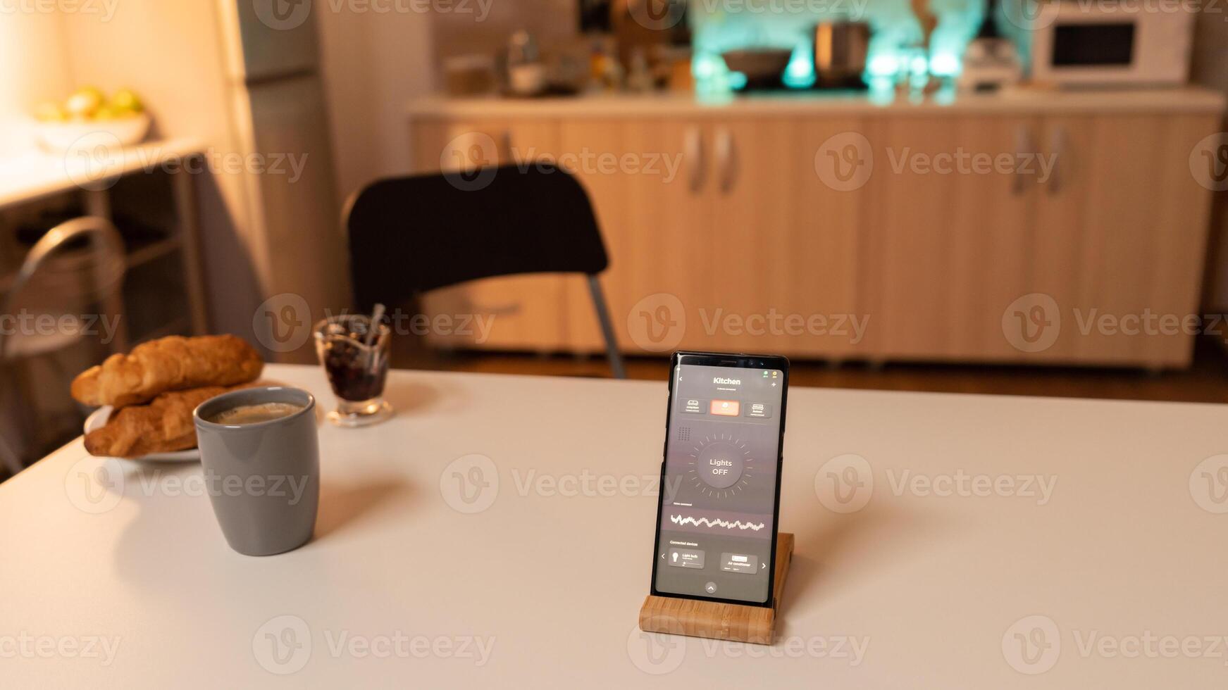 Lighting remote control system on smartphone. Phone with touching screen late at night with technology to change lights in home. photo