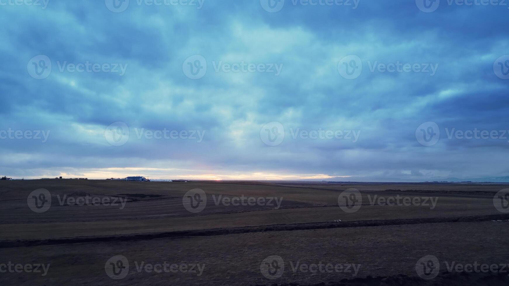 Aerial view of icelandic frosty fields in cold weather, fantastic arctic landscape with snowy mountains and colorful skies. Scandinavian countryside scenery with snow, scenic route. photo