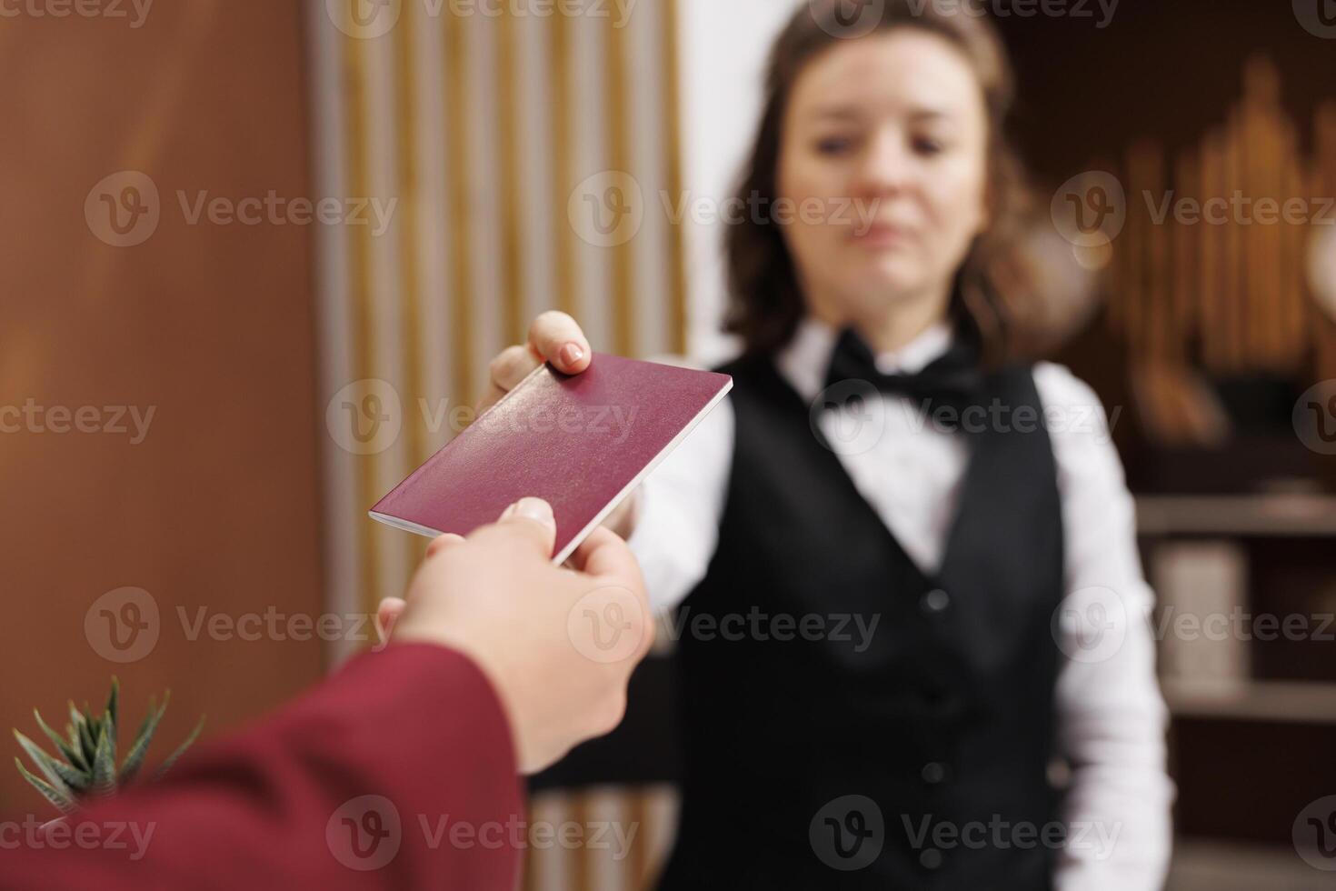 Receptionist asking for identification, taking passport from businessman to fill in registration forms and do check in procedure. Entrepreneur providing id documents. Close up. photo