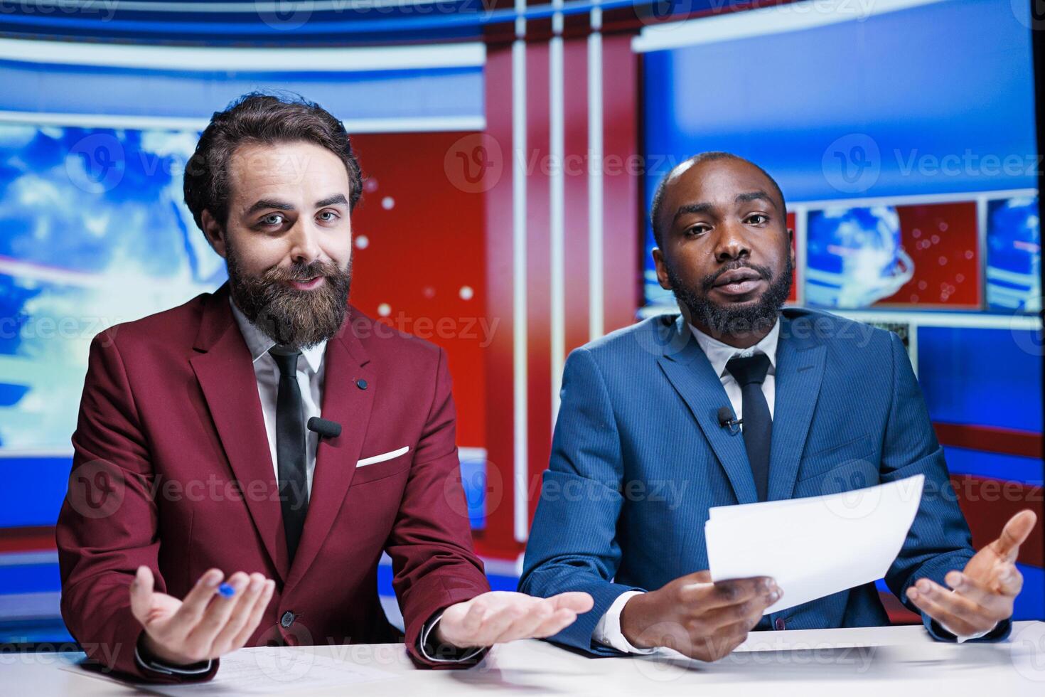 Morning show tv hosts reading headlines in newsroom, debating latest global information about daily events. Diverse team of reporters delivering newscast live with all important topics. photo