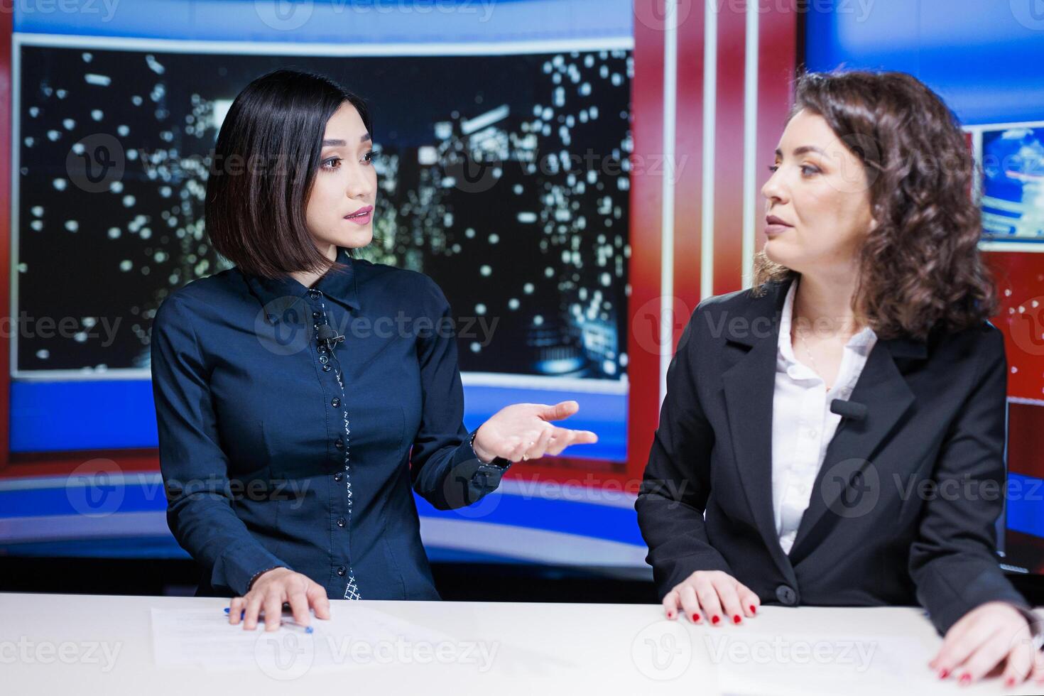 Diverse women presenters talk about latest news live on television broadcast, hosting late night show filled with exclusive details and information. Newscasters team presenting global issues. photo