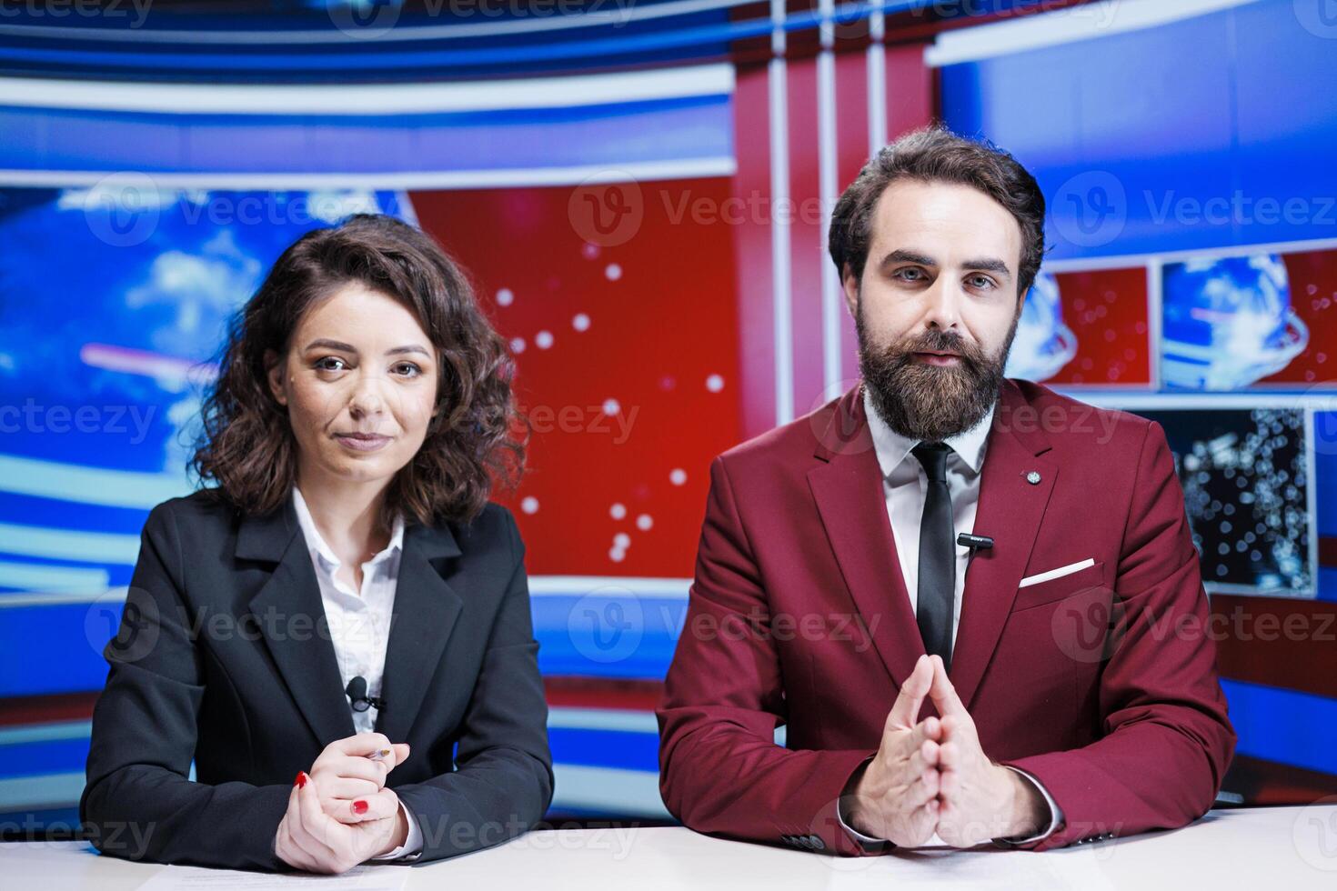 Journalists team reading headlines live on global tv channel, discussing about latest news on morning show. Two newscasters presenting important stories from around the world, television content. photo