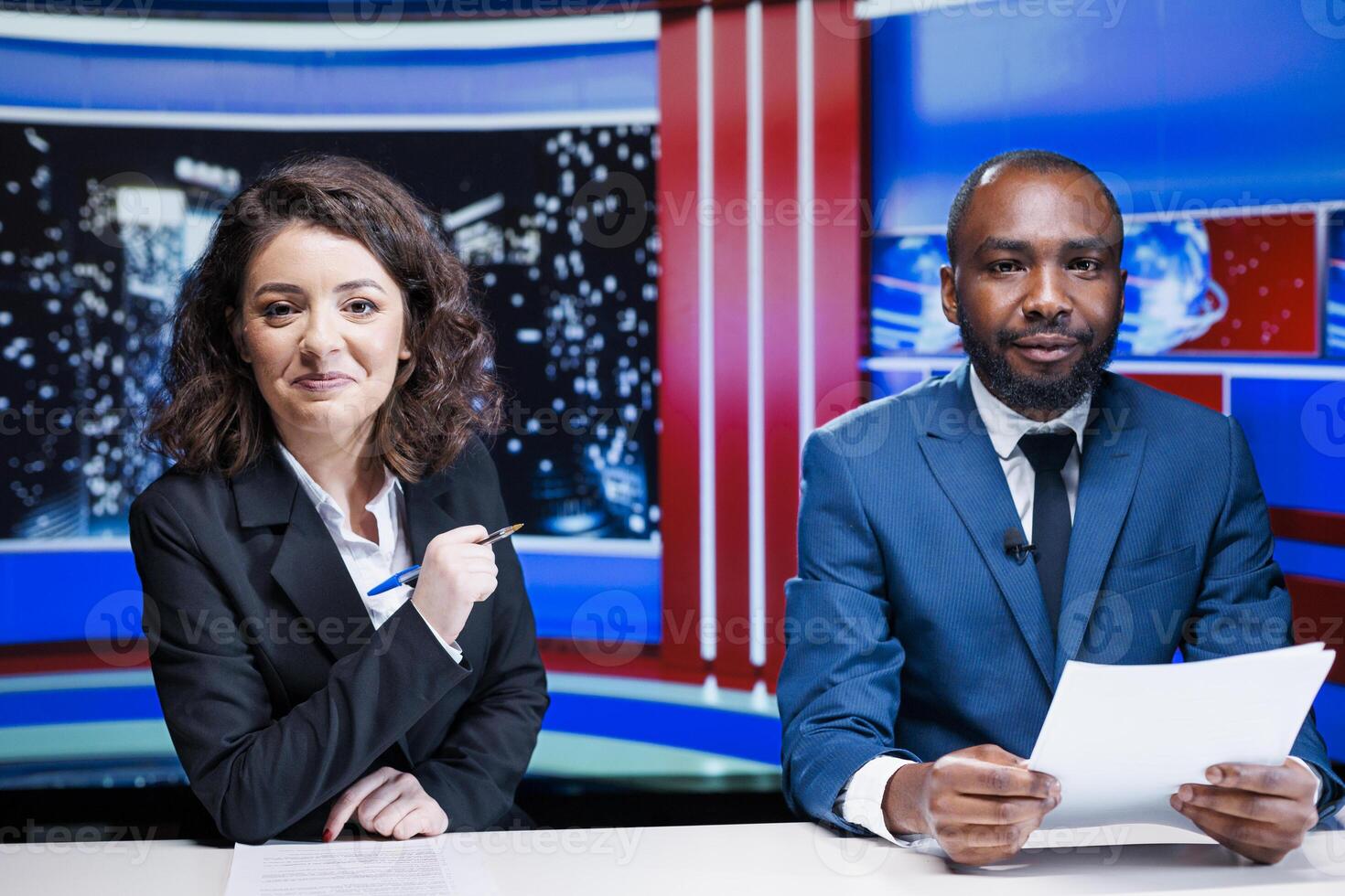 Journalists team reporting live news in newsroom, working to deliver latest information for international content. Diverse broadcasters covering all topics and global scandal events. photo