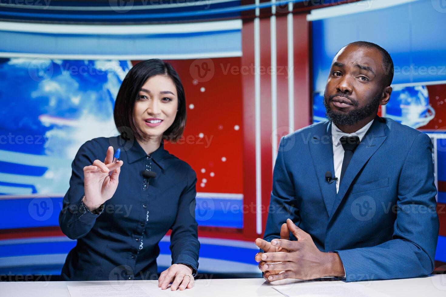 News presenters team on morning show addressing daily breaking news and providing information for exclusive content. Diverse newscasters team meeting in newsroom to debate topics. photo