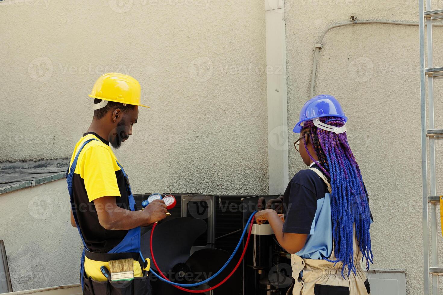 African american coworkers hired after complaints about noisy air conditioner and significant increase in energy bills. Engineers using professional manifold gauges to detect optimum fixing method photo