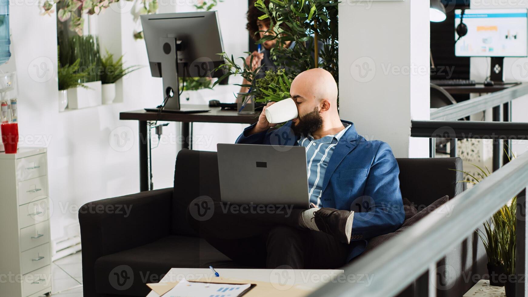 Business manager reviews analytics, examining annual results on online documents in coworking space. Analyst working with company statistics for research plan to create presentation. photo