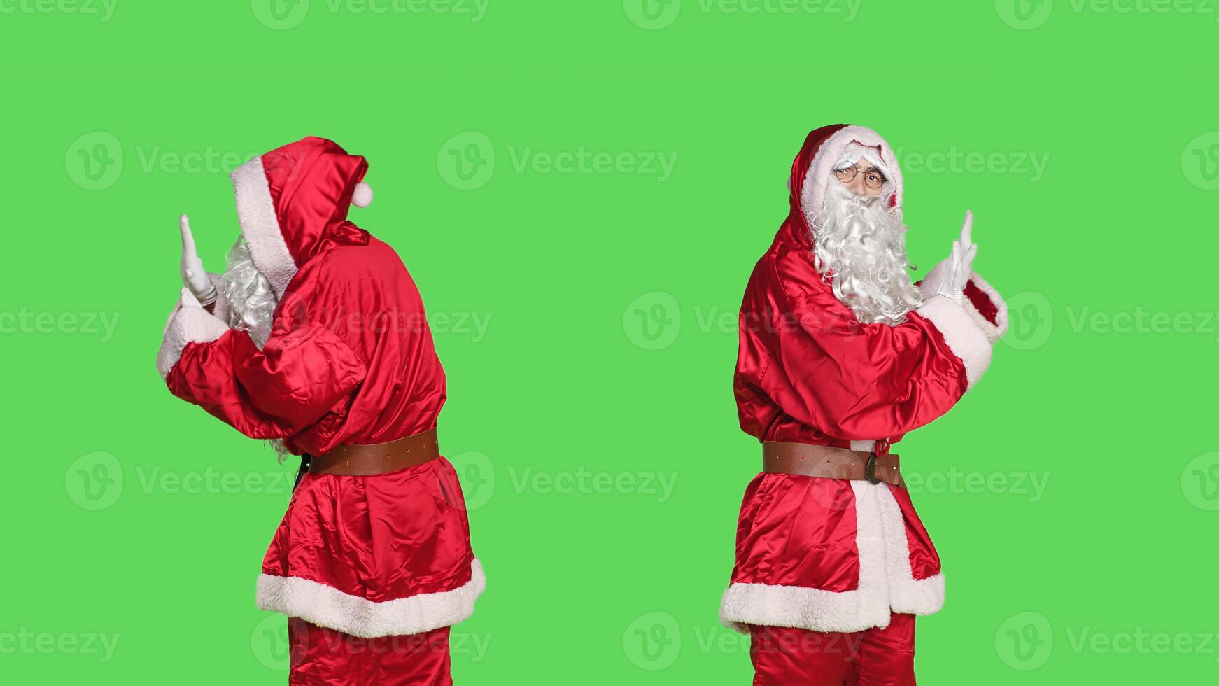 Saint nick pushing object left or right, pretending to refuse something against isolated greenscreen background. Young adult in santa festive costume doing rejection symbol aside. photo