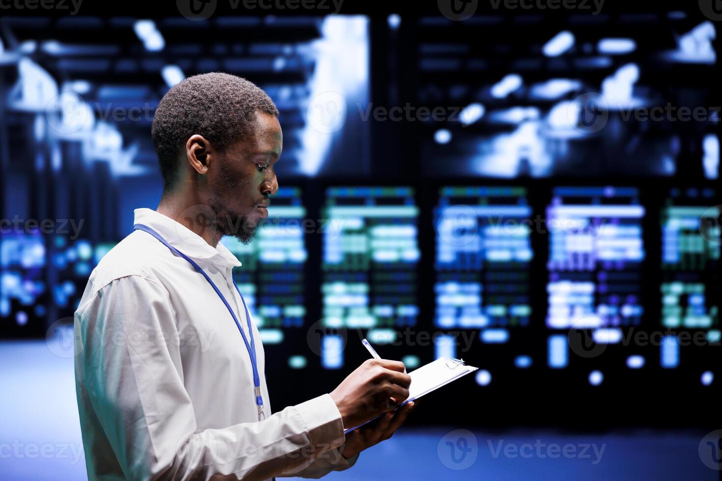 Adept supervisor overseeing server hub using renewable sources to minimize consumption and reduce overall facility carbon footprint. African american technician working in eco friendly data center photo