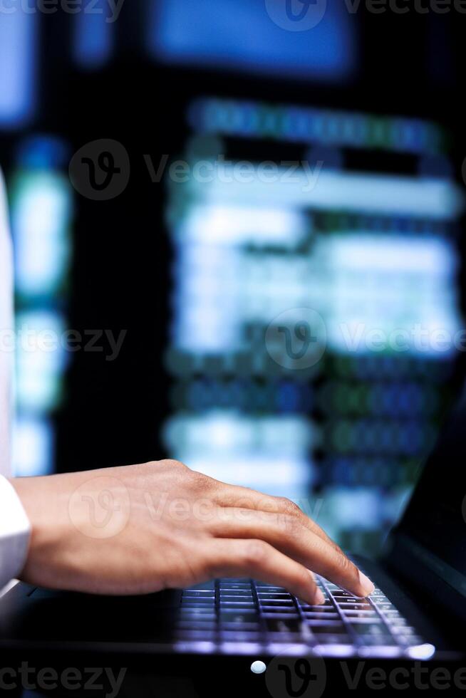 Engineer ensuring proper functioning of VPN servers with top security standards used to protect sensitive data, close up. Admin using laptop to check equipment providing internet connections for users photo