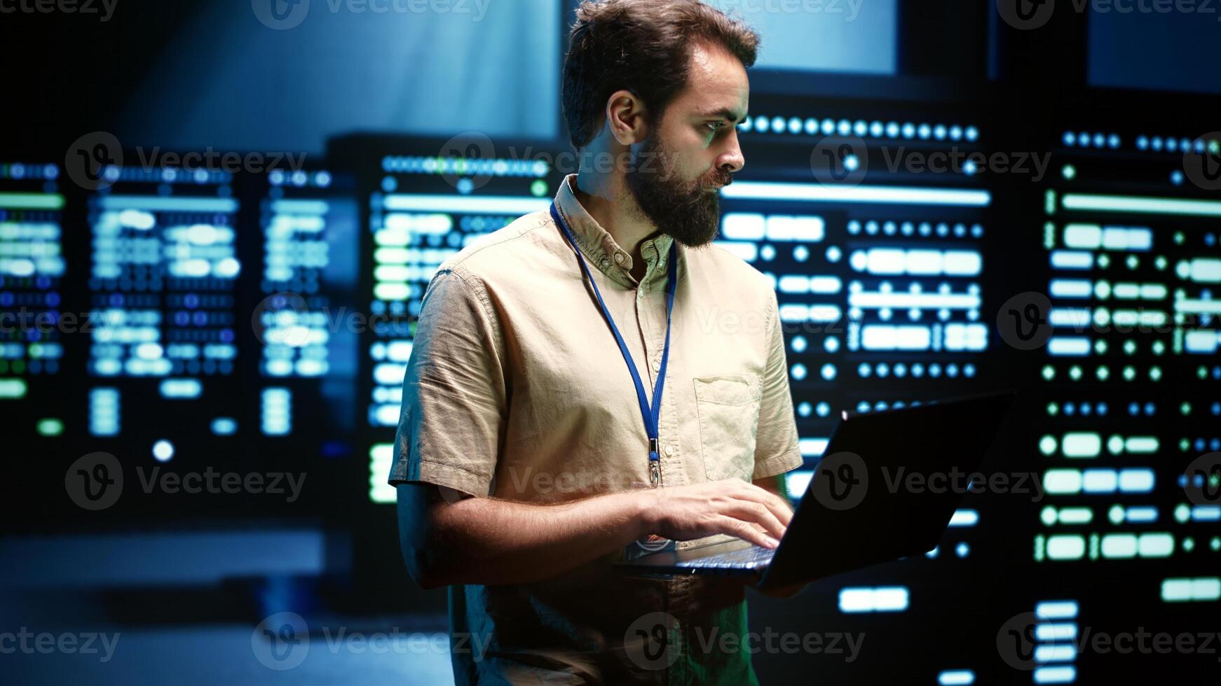 Close up of adept technician using laptop to check operational server hub. Hardware clusters in data storage and cloud computing business service providing processing for several workloads photo