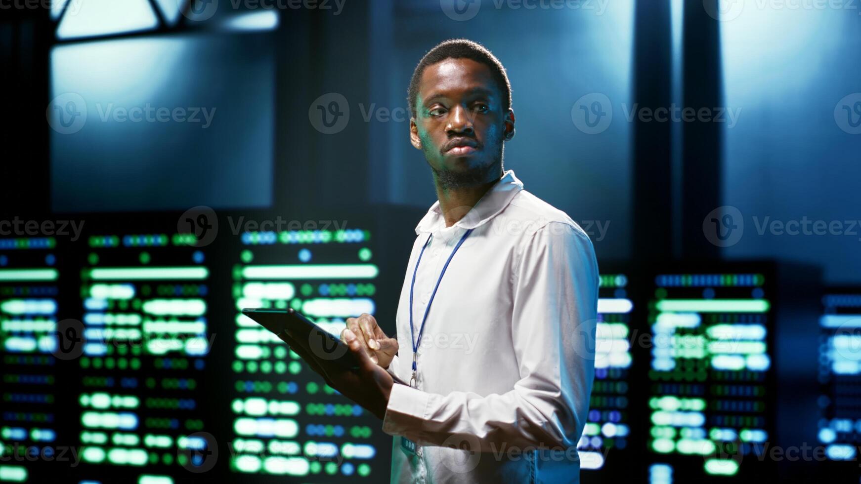Computer scientist using tablet to check server room security features protecting against unauthorized access, data breaches, distributed denial of service attacks and other cybersecurity threats photo