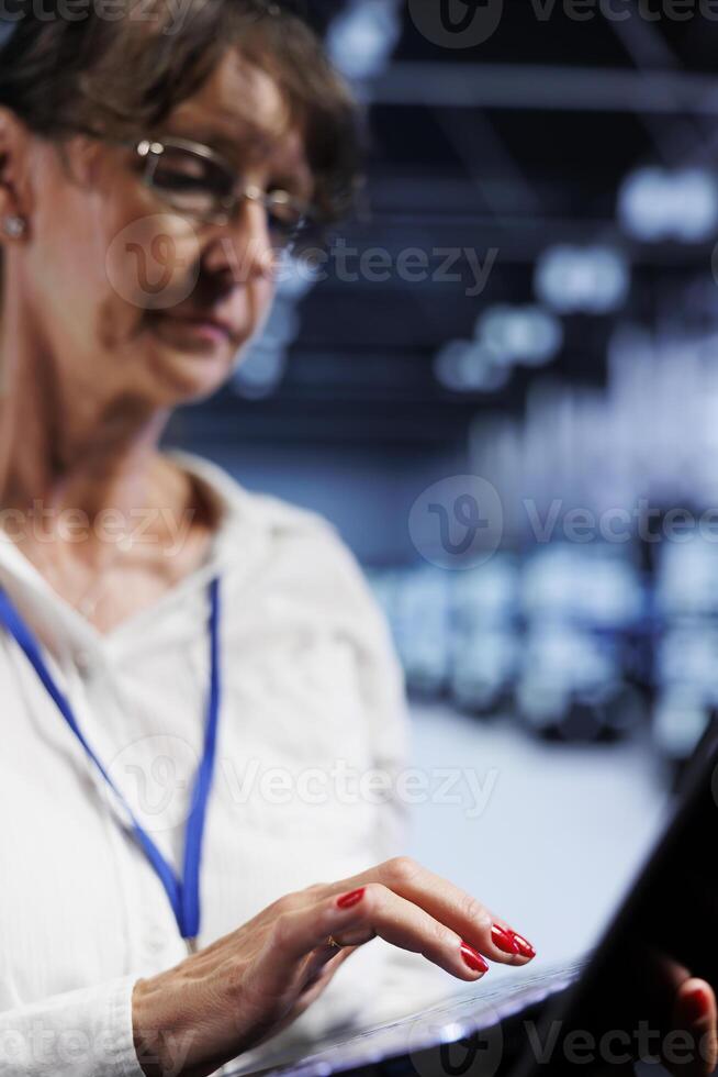 Proficient worker using laptop, ensuring data remains shielded from potential security jeopardy, safeguarding server room infrastructure against unauthorized access and vulnerabilities, close up photo