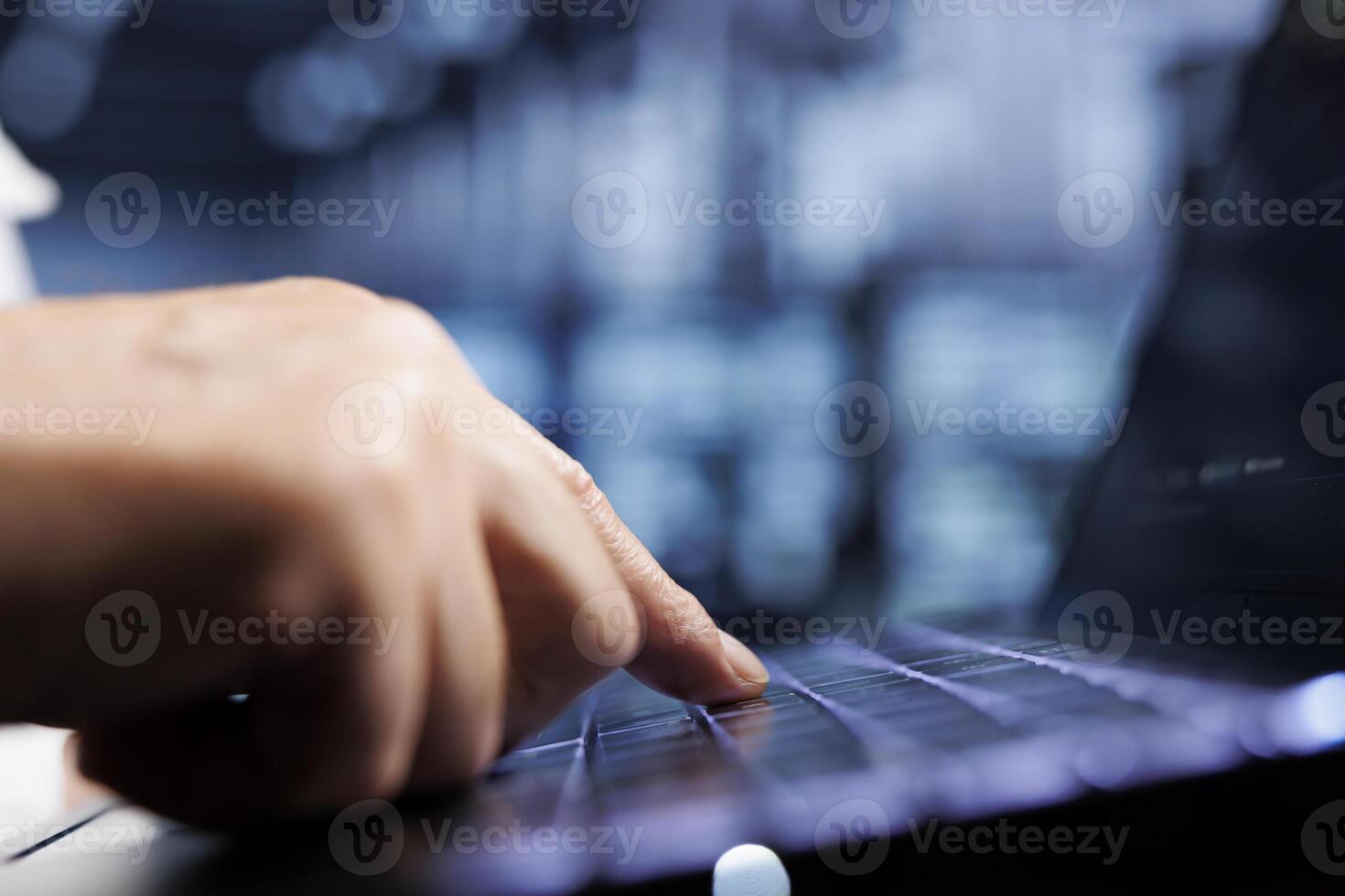 Cloud computing company executive using laptop to examine server racks for power fluctuations, close up. Trained employee monitoring high tech data center rigs parts, identifying potential errors photo