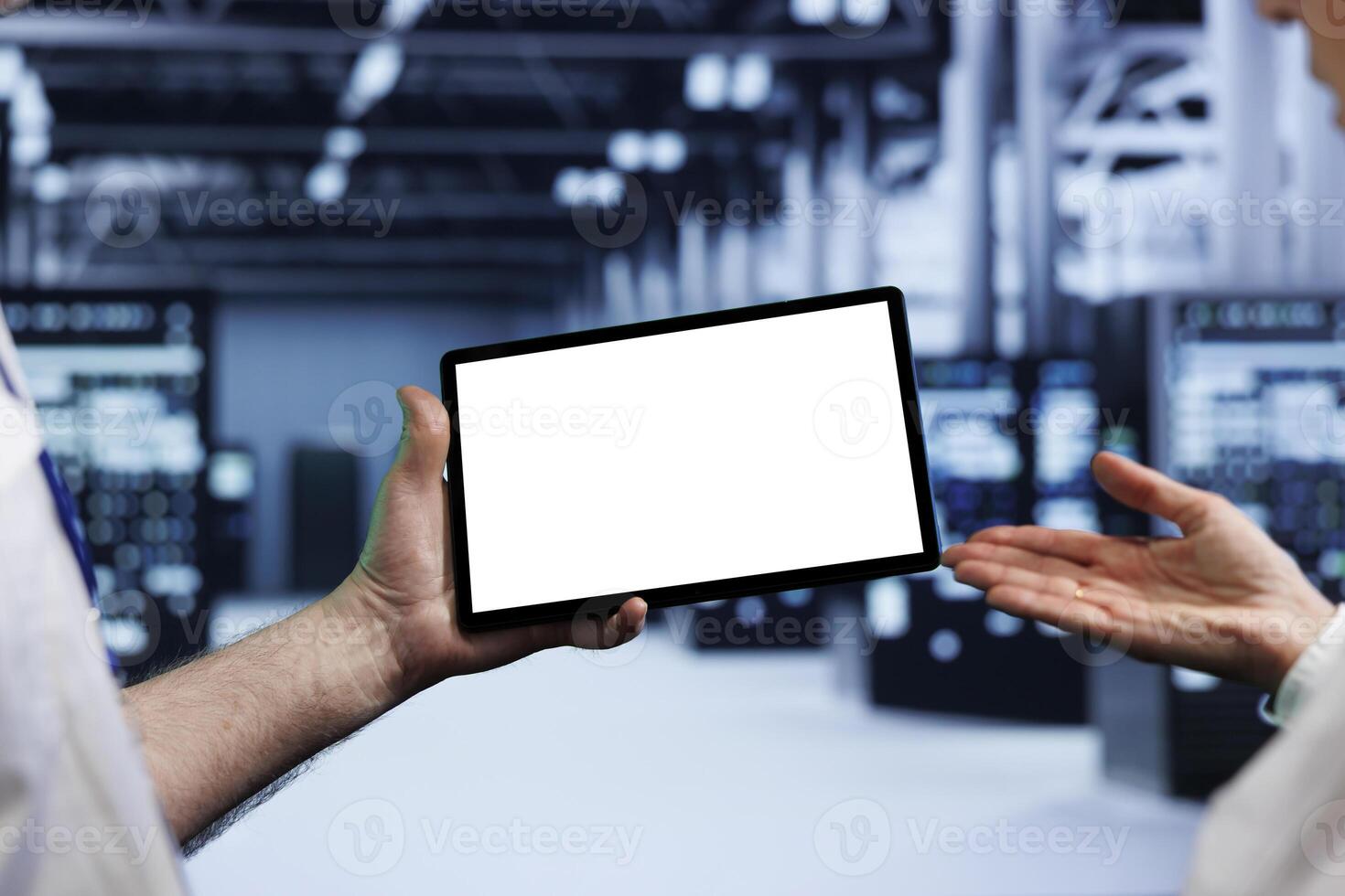 Senior teamworking colleagues in high tech workplace using mock up tablet to set up configuration management tools that enable automatic failover and load balancing, preventing server parts failure photo
