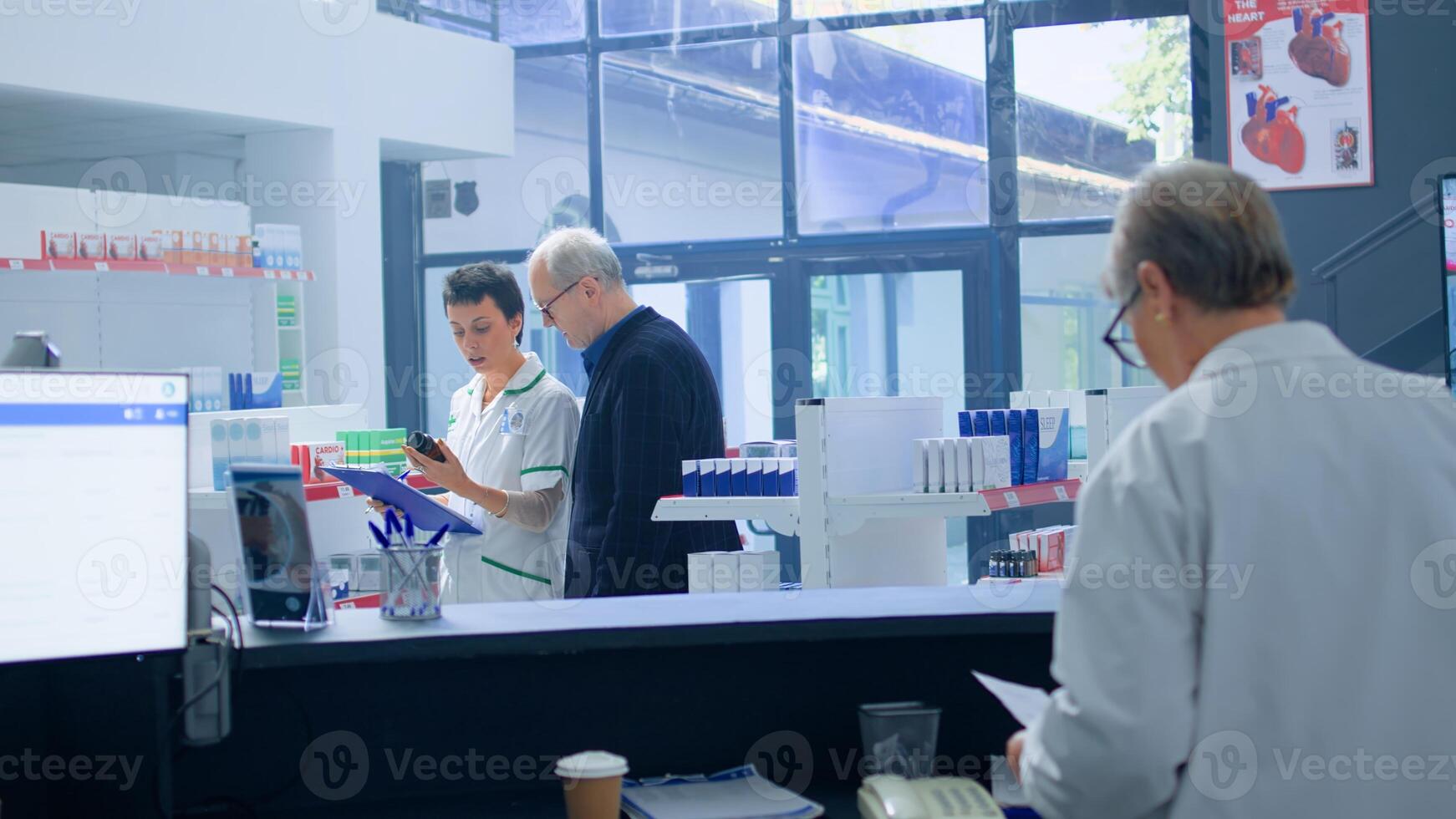Senior man in need of prescription antibiotic informations in apothecary, requesting expertise from cashier who redirects him to licensed chemist checking pharmaceutical products inventory photo