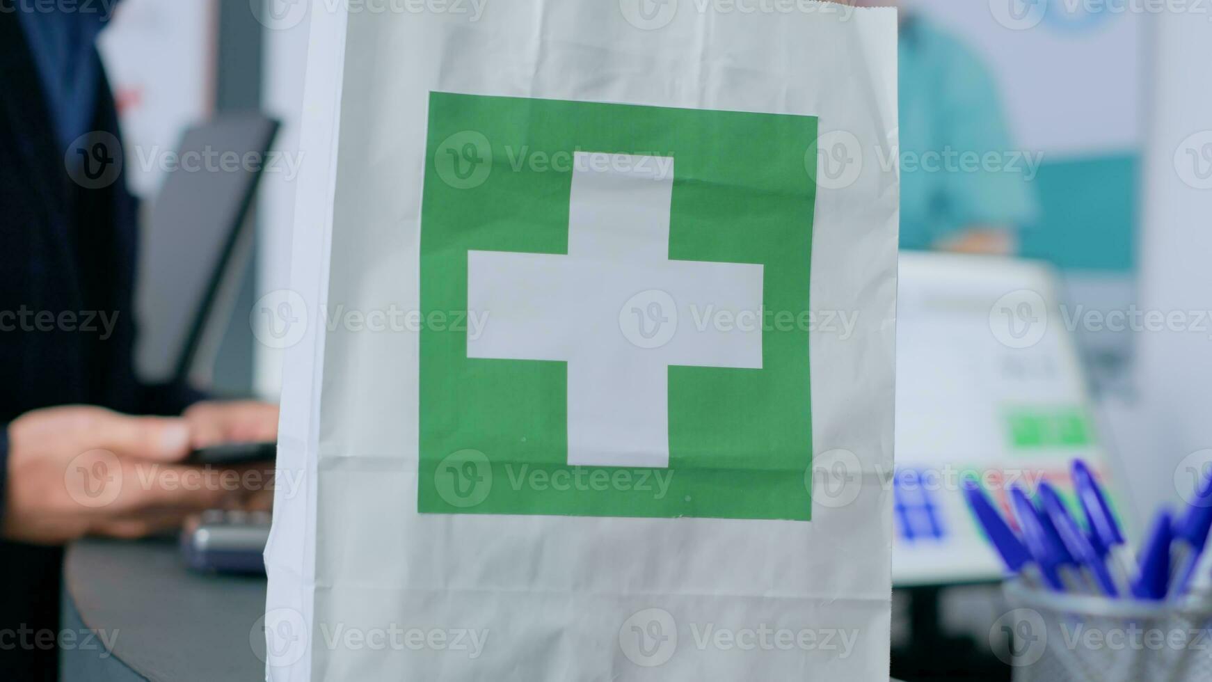 Shopper at drugstore counter, showing worker prescribed heart specialist prescribed pills, ready to buy them. Pharmacist assisting client with required pain treatment tablets, close up photo