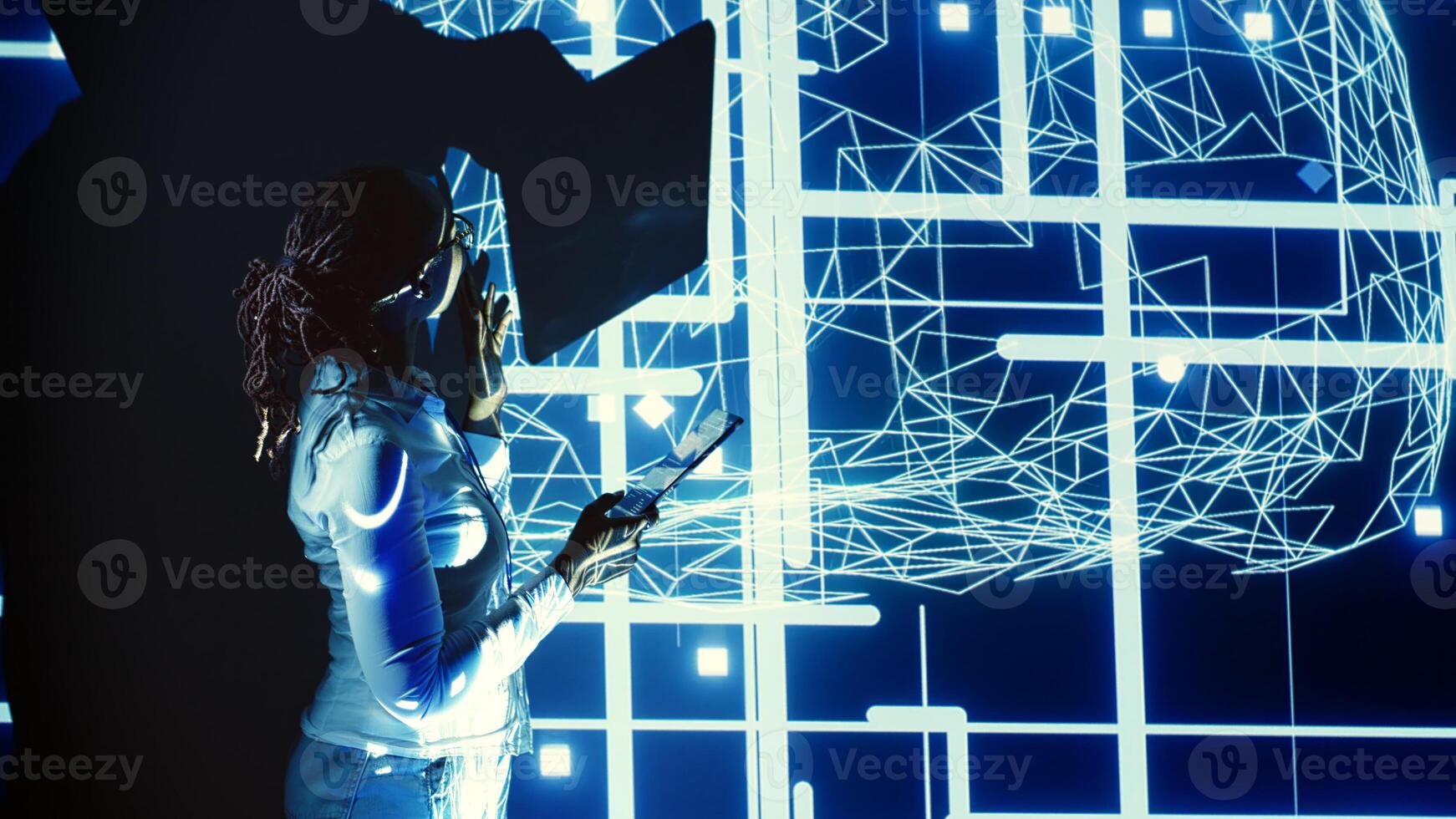 System administrator programming in AI server farm housing advanced equipment used for machine learning training. Programmer running code on tablet to update artificial intelligence rigs photo