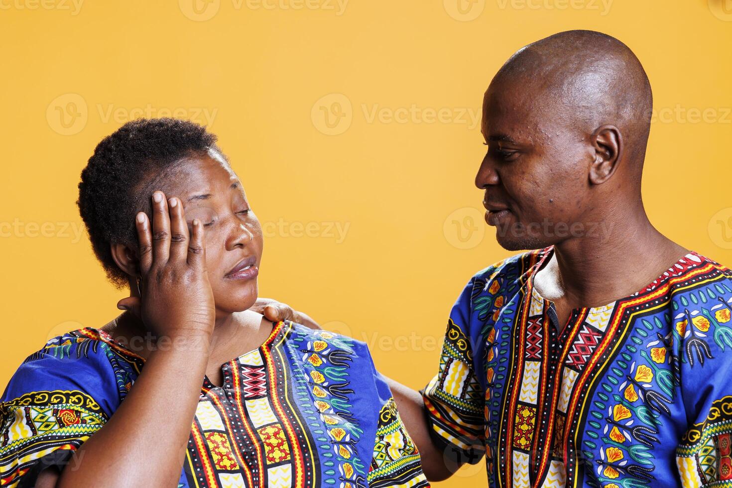 African american woman holding head while suffering from migraine, getting help and care from man. Loving husband supporting wife with headache and high blood pressure symptom photo