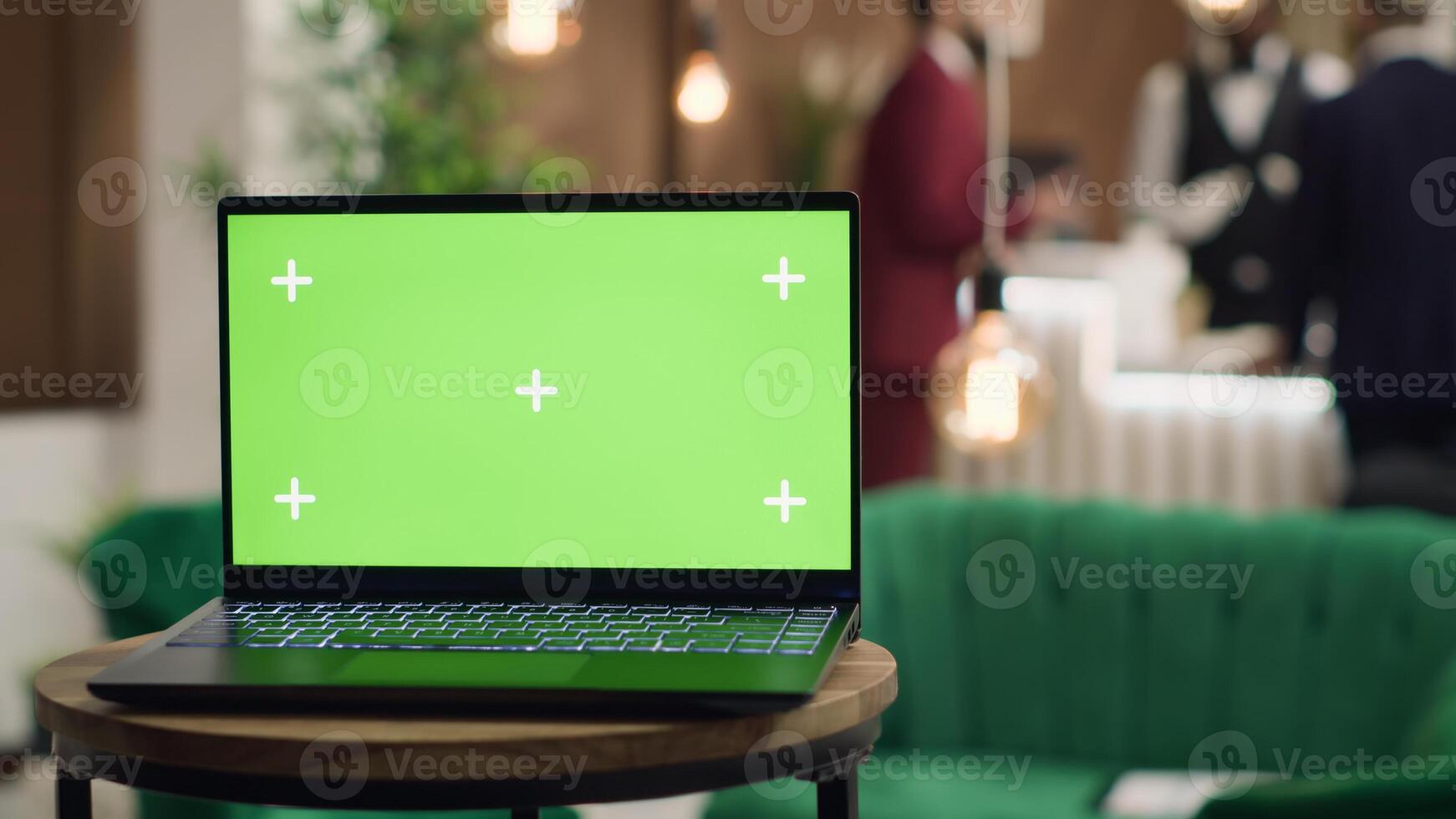 At front desk is a device with isolated greenscreen layout, guests entering reception area are travelling on company business trips. Managers attending official meetings in an elite hotel. photo