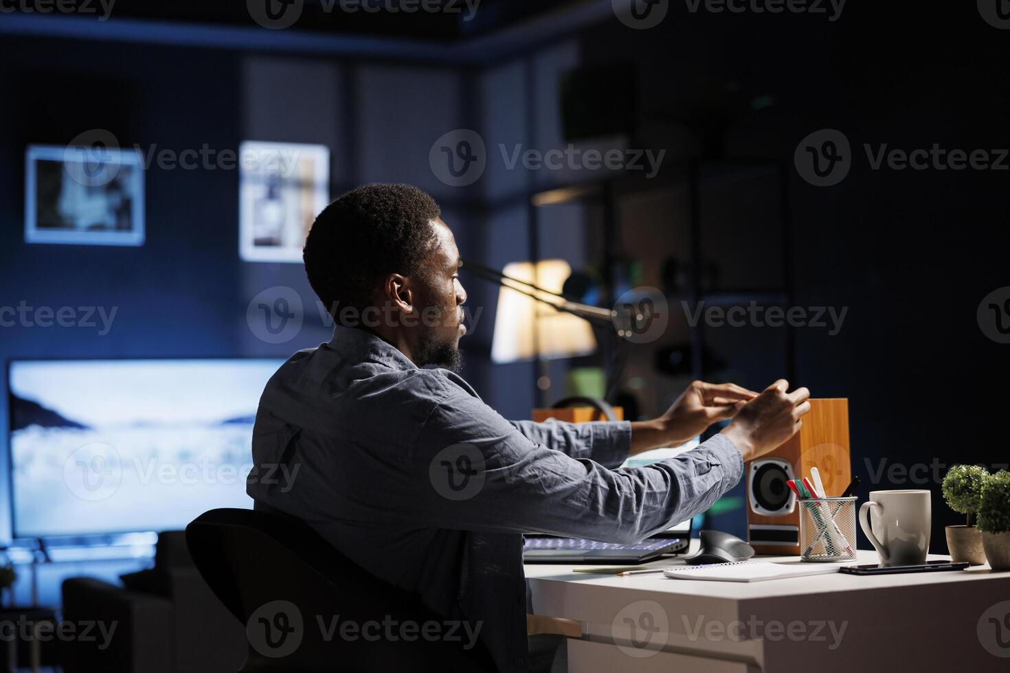 Young man writing sticky notes reminders while studying business administration and management, trying to research and learn economy knowledge. Student attends online classes program. photo