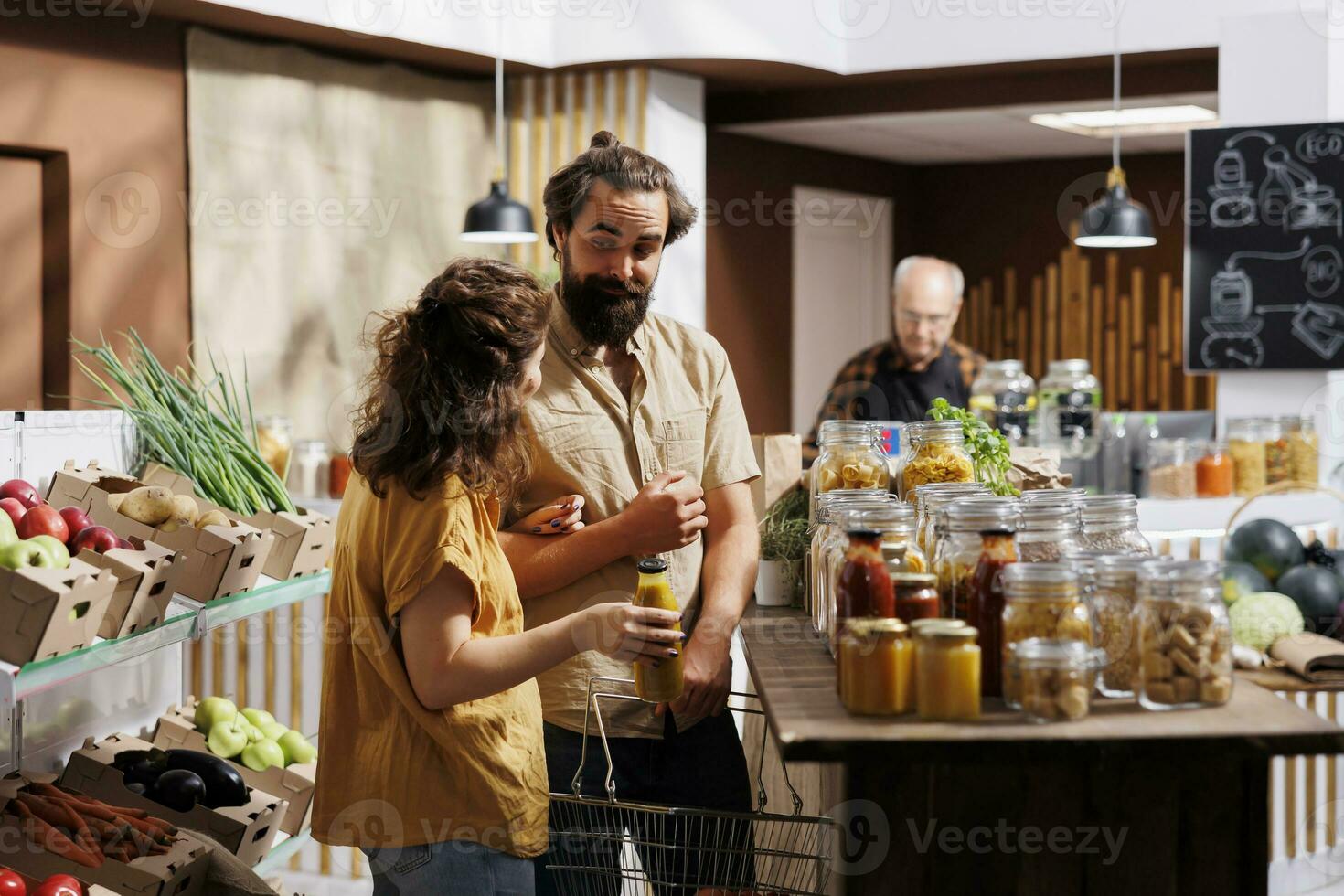 Green living couple shopping in zero waste supermarket, happy to find organic food. Vegan customers preparing for winter, purchasing pantry staples from eco friendly local neighborhood store photo