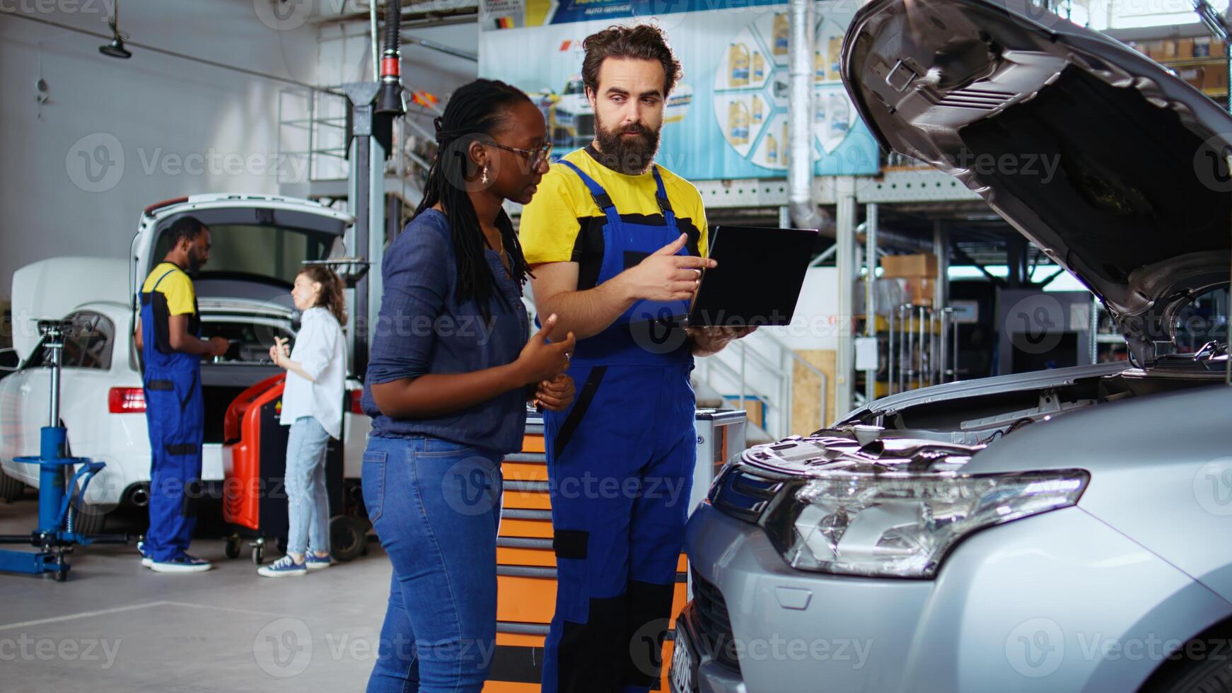 Mechanic in car service picks torque wrench from work station bench, using it to tighten bolts after replacing engine. Auto repair shop employee uses professional tools to fix client automobile photo